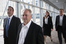 Former Starkey Hearing Technologies president Jerry Ruzicka and former Starkey human resources manager Larry Miller, right, leave the federal courthou