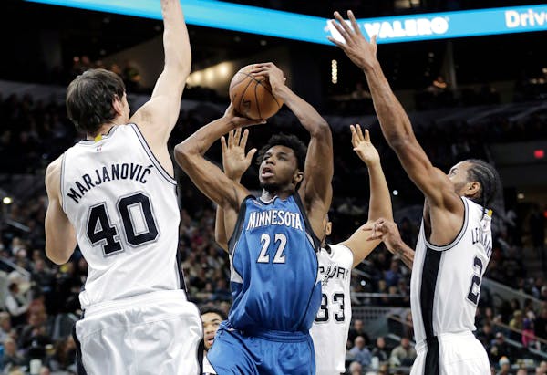 Timberwolves guard Andrew Wiggins shot over Spurs center Boban Marjanovic during the first half Monday night.