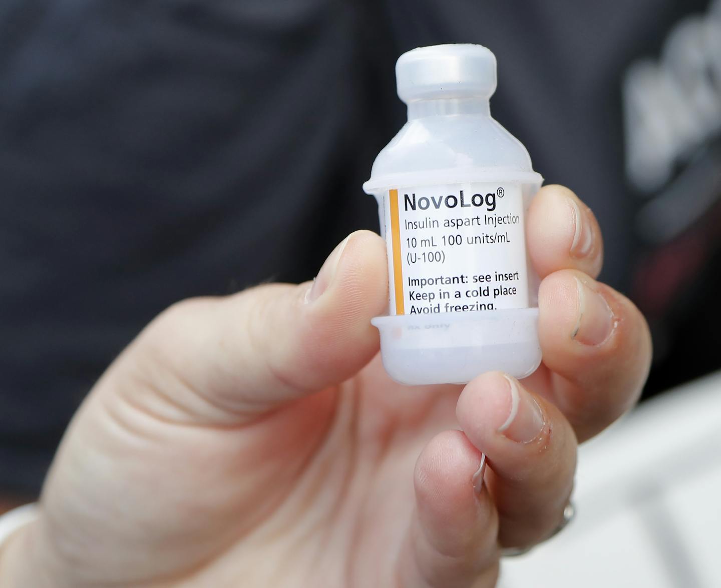 A patient holds a vial of insulin during a news conference outside the Olde Walkersville Pharmacy, Sunday, July 28, 2019, in Windsor, Ont. Democratic presidential candidate, Sen. Bernie Sanders, I-Vt., and a busload of insulin patients stopped in Windsor to purchase the drug to highlight the high costs of the insulin in the United States. (AP Photo/Carlos Osorio)