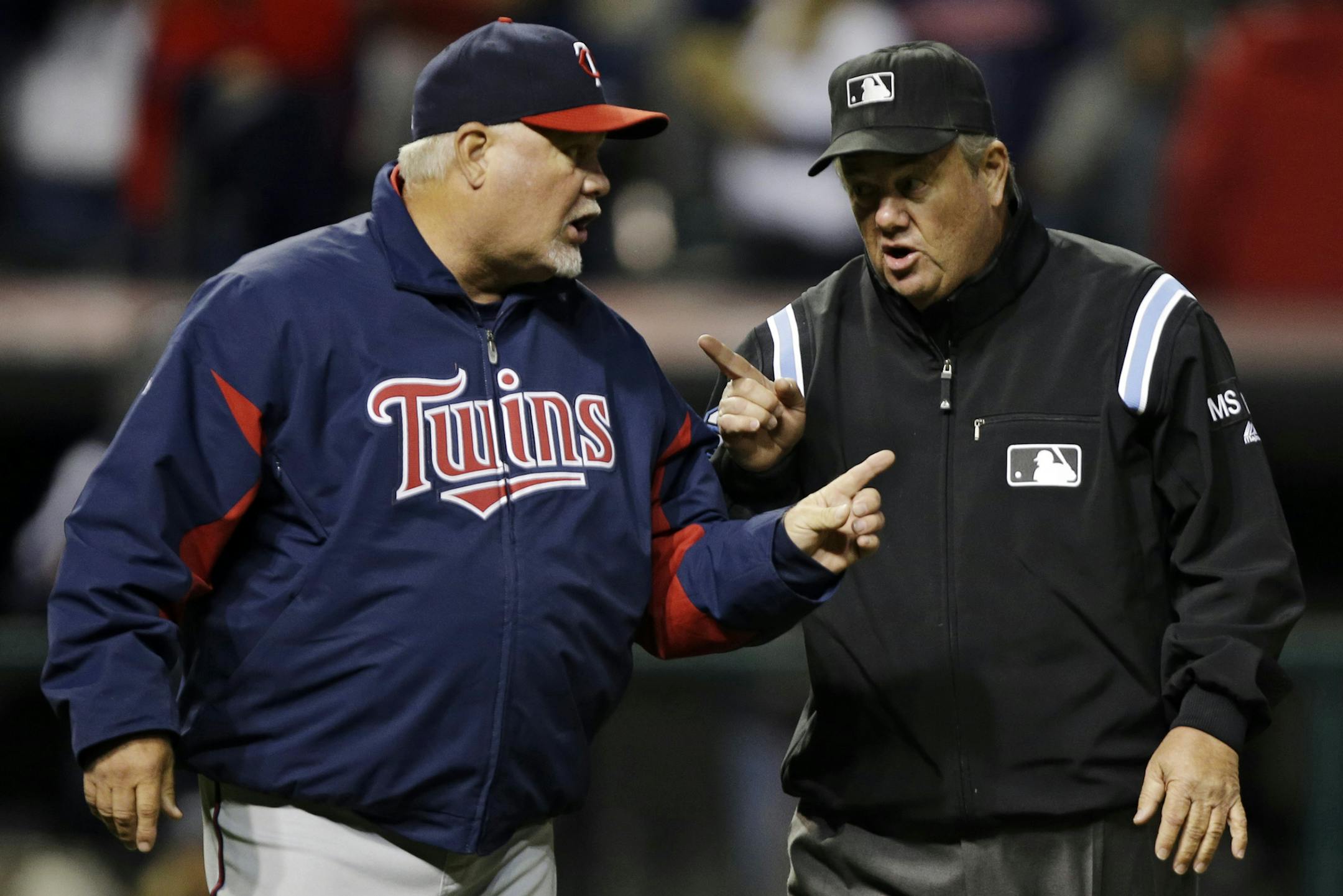 Minnesota Twins manager Ron Gardenhire, left, argues with umpire Joe West in the eighth inning of a baseball game against the Cleveland Indians, Wednesday, Sept. 19, 2012, in Cleveland. A line drive by Joe Mauer was initially ruled a single, but the umpiring crew met and concluded Cleveland Indians left fielder Vinny Rottino made the catch. (AP Photo/Mark Duncan)
