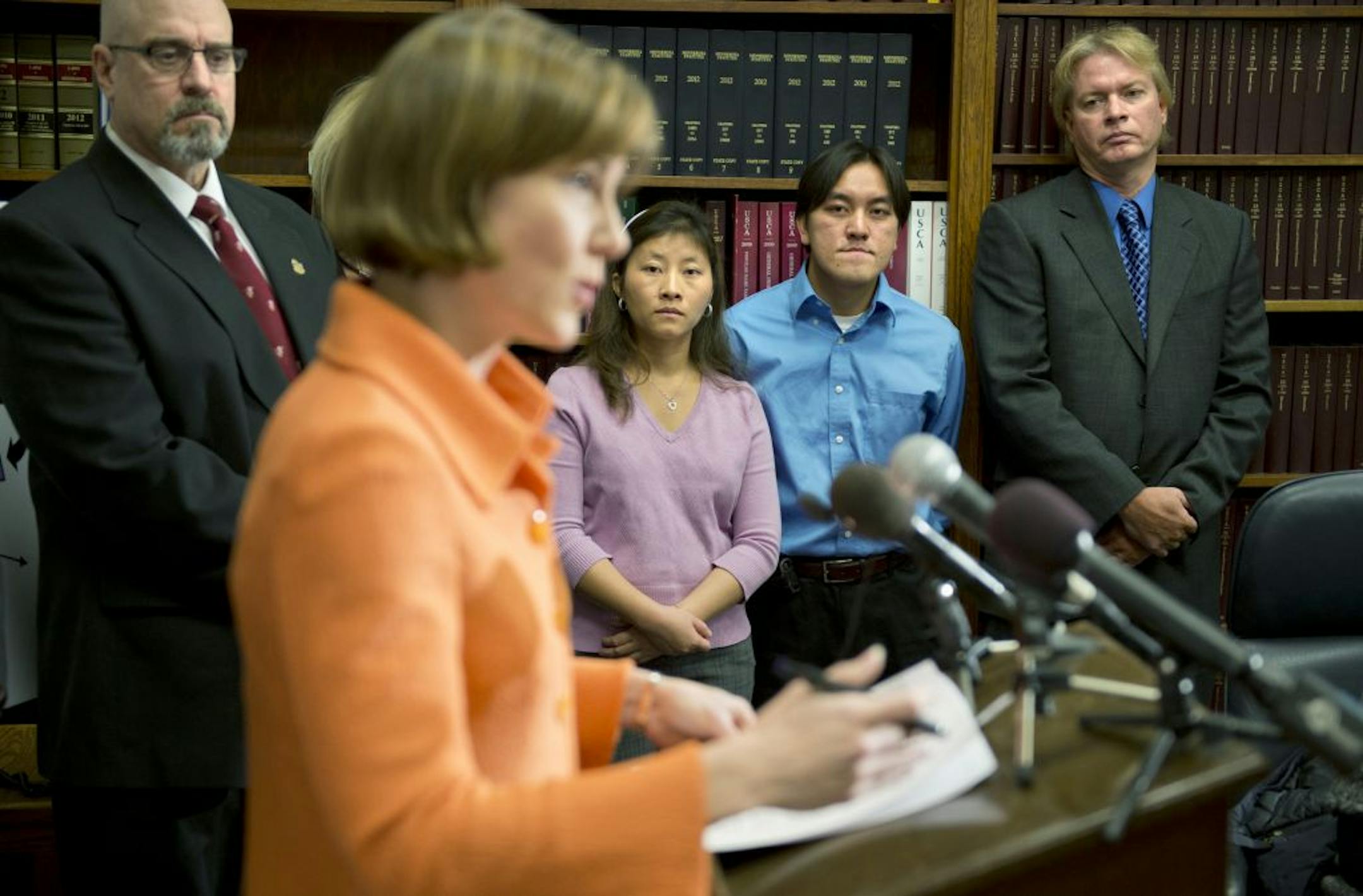 Ka Yang, center, said she hired a lawyer for $2,000 to get back the $9,000 Midland Funding LLC wrongly took from her bank account.
