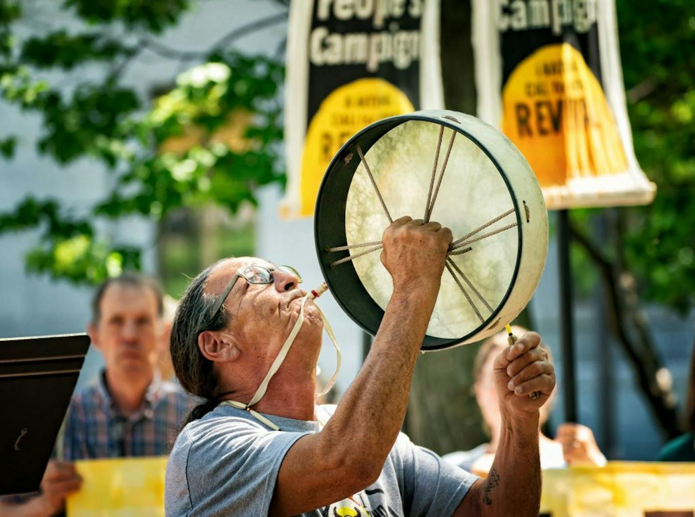 Dakota elder Bob Klanderud sang and played the drum and whistle at the start of the rally. Over a hundred people attended a rally in Leif Erickson Park across from the State Capitol to call for a halt in the construction of Enbridge's Line Three that would go through tribal lands.