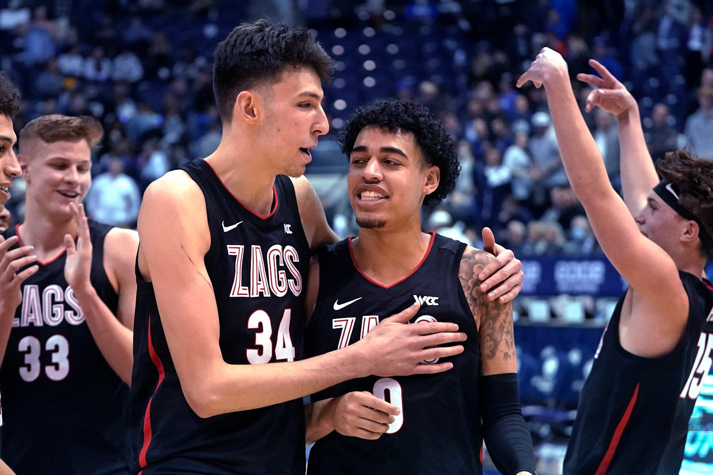 Gonzaga center Chet Holmgren (34) andguard Julian Strawther (0) walk off the court following the team's win in an NCAA college basketball game against BYU on Saturday, Feb. 5, 2022, in Provo, Utah. (AP Photo/Rick Bowmer)