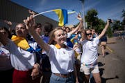 Ukrainian teens Kira Sukhoboichenko, Margaret Linnyk and Kamilla Detkinaon waved at other parade floats before hopping on the 4H float to represent th
