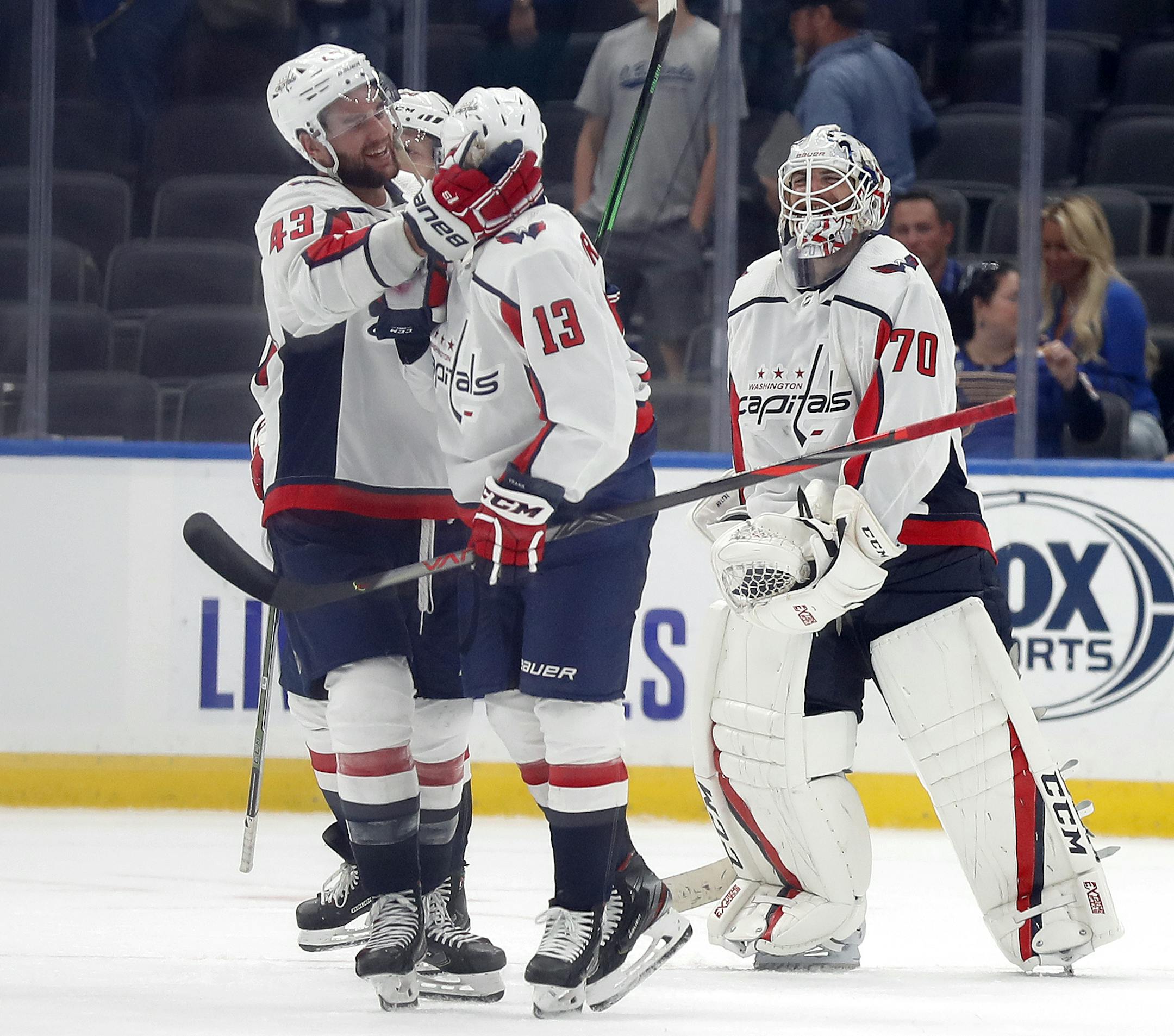 Washington Capitals' Jakub Vrana (13), of the Czech Republic, is congratulated by teammate Tom Wilson (43) and Braden Holtby (70) after scoring the game-winning goal during overtime of an NHL hockey game against the St. Louis Blues Wednesday, Oct. 2, 2019, in St. Louis. The Capitals won 3-2 in overtime. (AP Photo/Jeff Roberson)