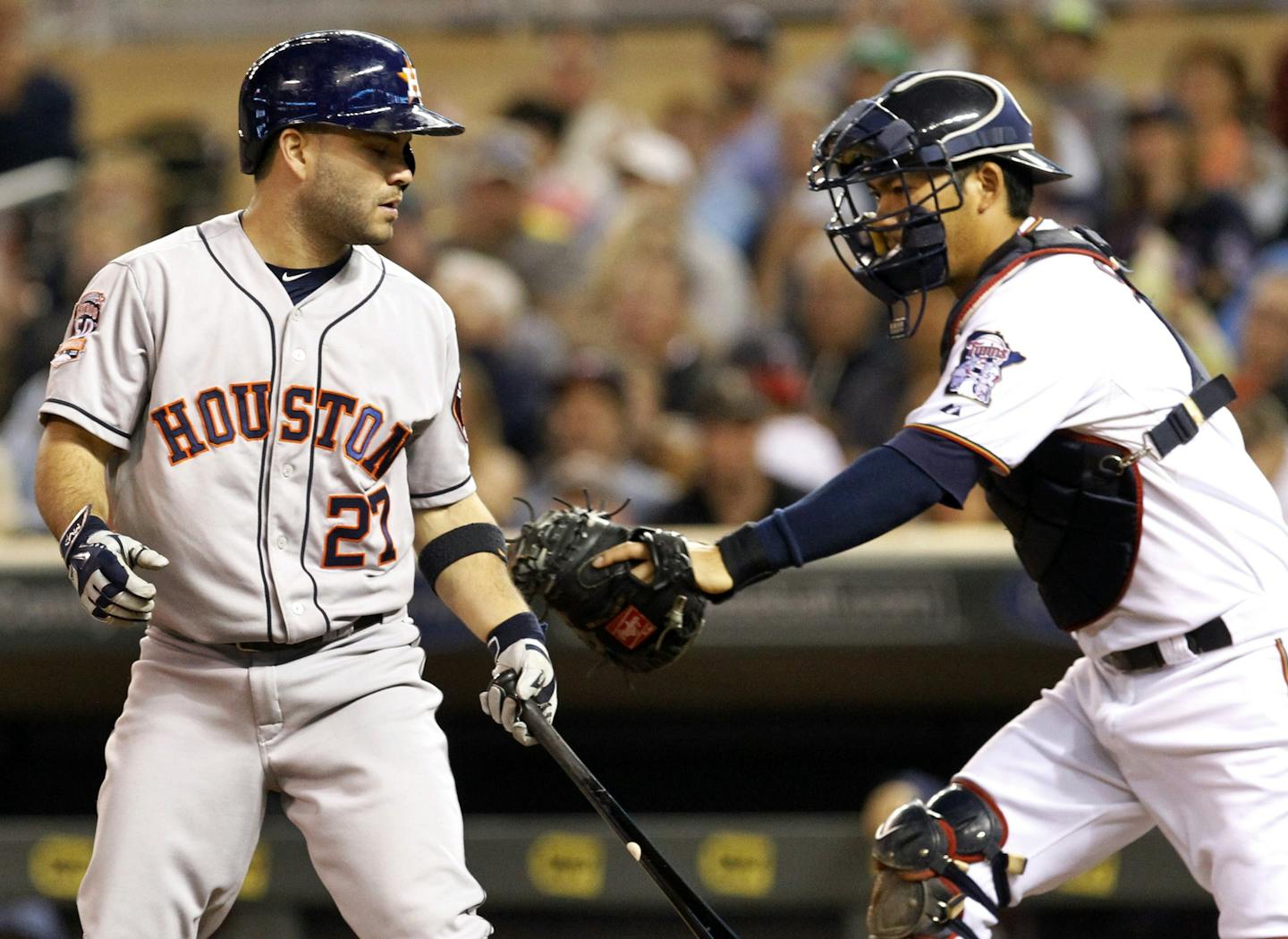 Minnesota Twins catcher Kurt Suzuki, right, tags Houston Astros' Jose Altuve (27) after Altuve's third strike during the seventh inning of a baseball game in Minneapolis, Friday, Aug. 28, 2015. The Twins won 3-0. (AP Photo/Ann Heisenfelt)