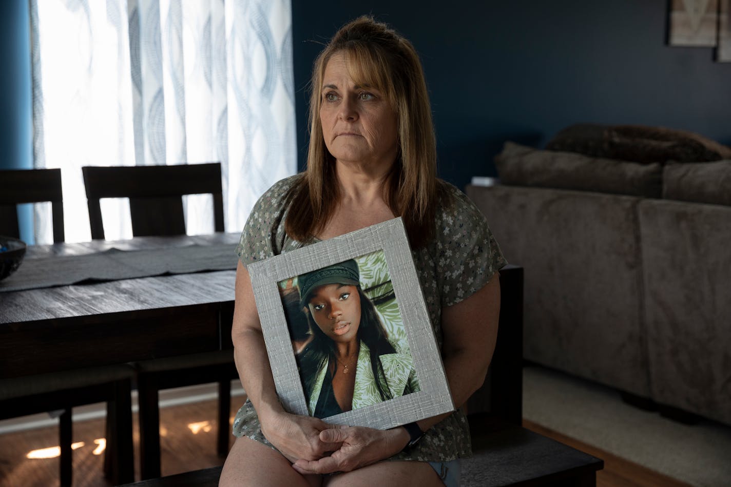 Christine Hill poses for a portrait inside her home holding a photograph of her daughter, Jadyen Hill. MUST CREDIT: Photo for The Washington Post by Elaine Cromie