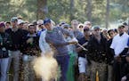 Jordan Spieth hits out of the rough off the 17th fairway during the third round of the Masters golf tournament Saturday, April 9, 2016, in Augusta, Ga