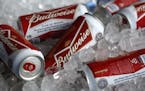 FILE - In this Thursday, March 5, 2015, file photo, Budweiser beer cans are seen at a concession stand at McKechnie Field in Bradenton, Fla. A British