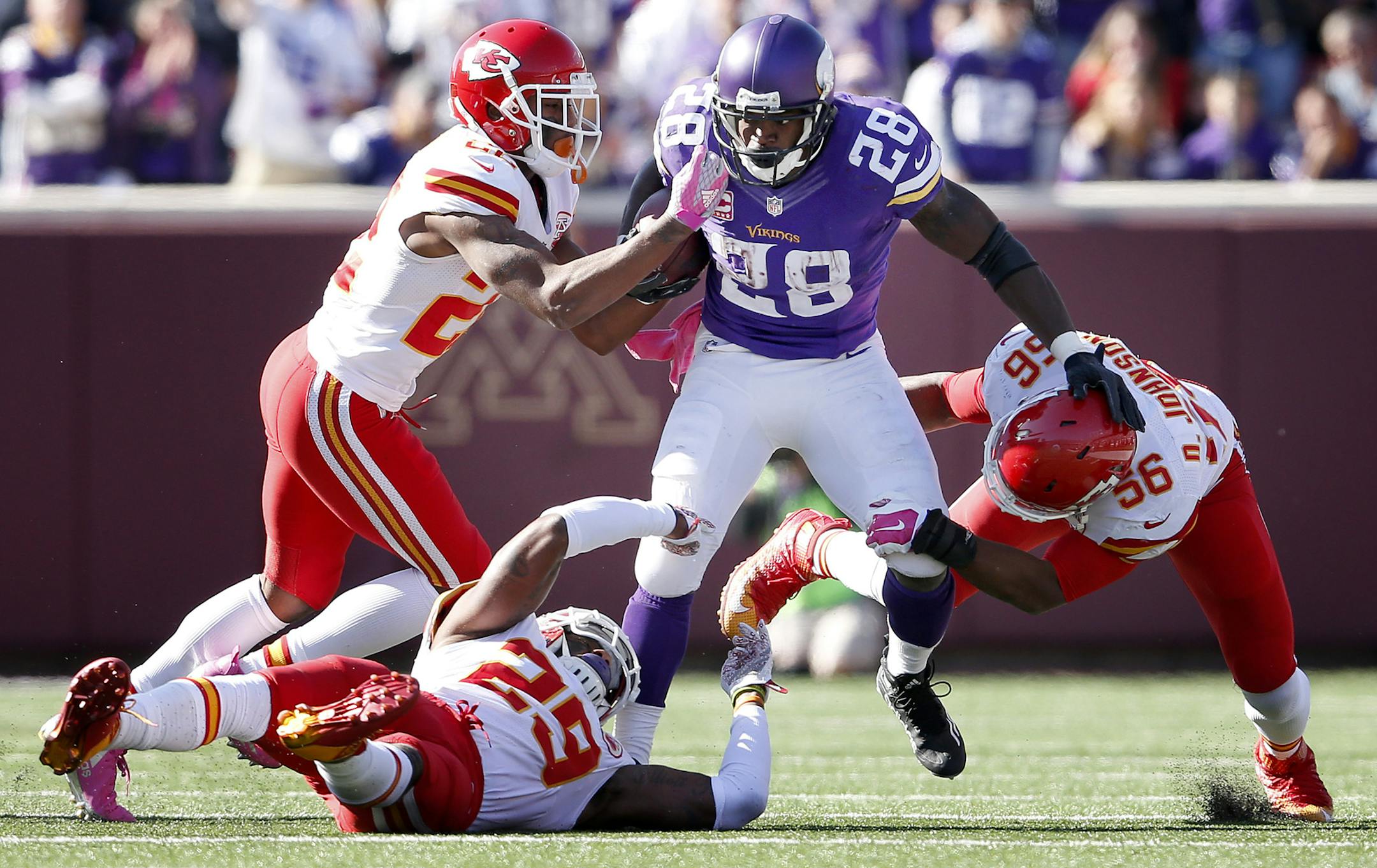 Minnesota Vikings running back Adrian Peterson (28) was tackled a gang of Chiefs defenders after a 23-yard run in the third quarter. ] CARLOS GONZALEZ ï cgonzalez@startribune.com - October 18, 2015, Minneapolis, MN, TCF Bank Stadium, NFL, Minnesota Vikings vs. Kansas City Chiefs