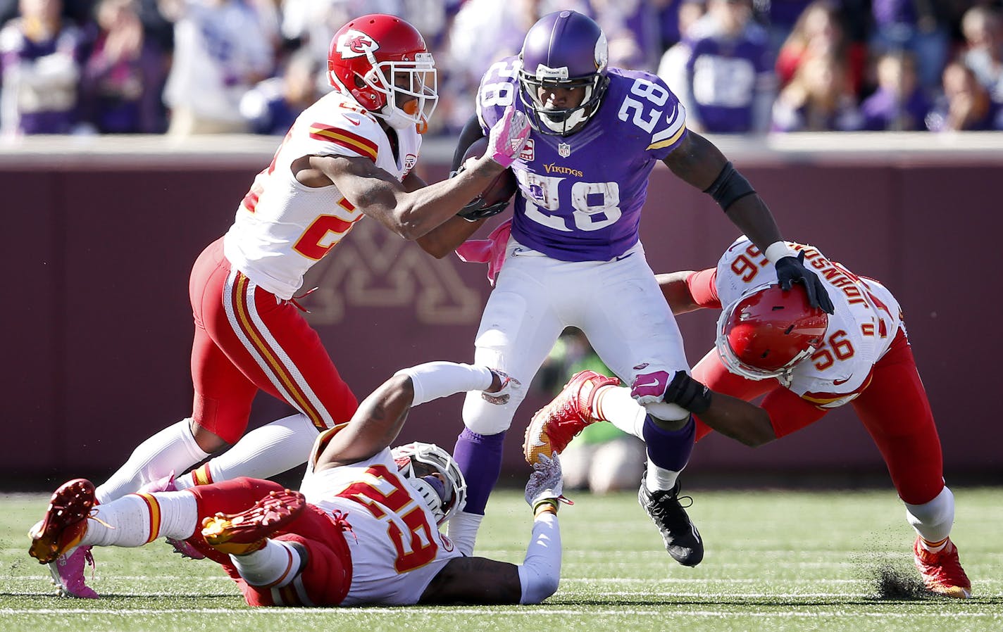 Minnesota Vikings running back Adrian Peterson (28) was tackled a gang of Chiefs defenders after a 23-yard run in the third quarter. ] CARLOS GONZALEZ &#xef; cgonzalez@startribune.com - October 18, 2015, Minneapolis, MN, TCF Bank Stadium, NFL, Minnesota Vikings vs. Kansas City Chiefs