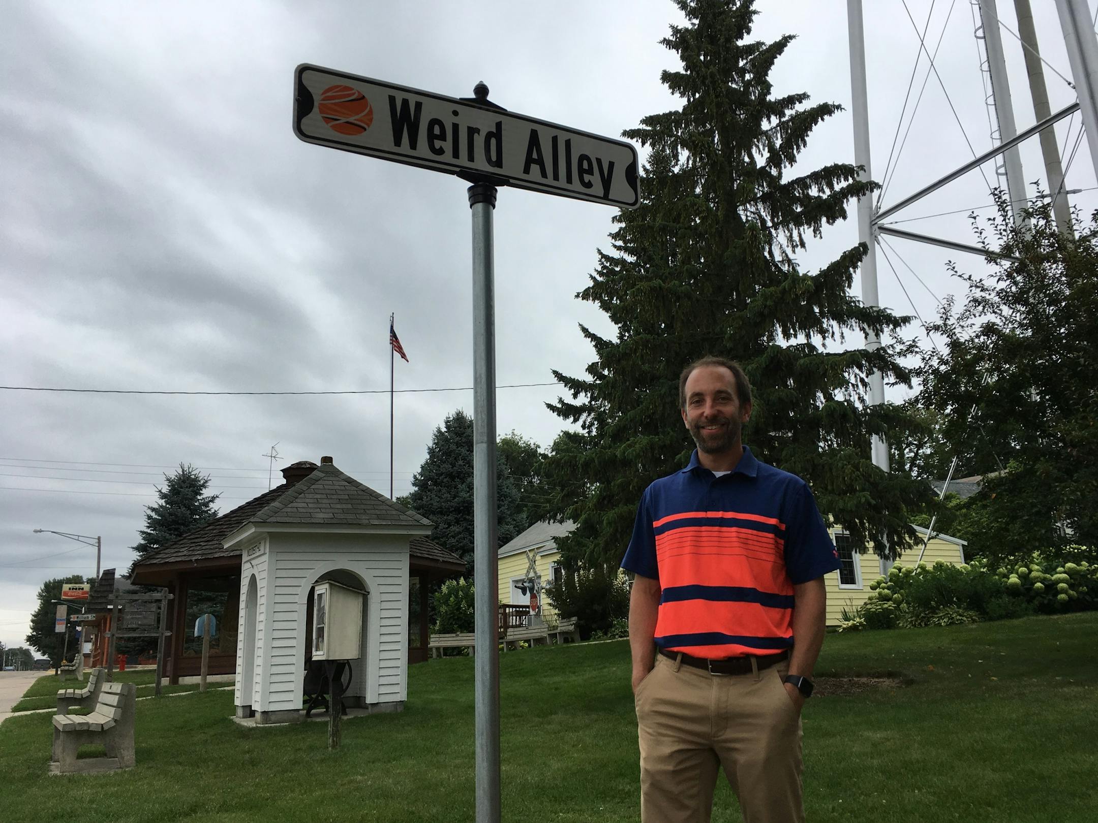 Josh Johnson, mayor of Darwin, Minn., personally installed a new street sign last week in honor of musician "Weird Al" Yankovic, who immortalized the city's giant ball of twine in a song. The twine ball sits in the brown structure at back left.