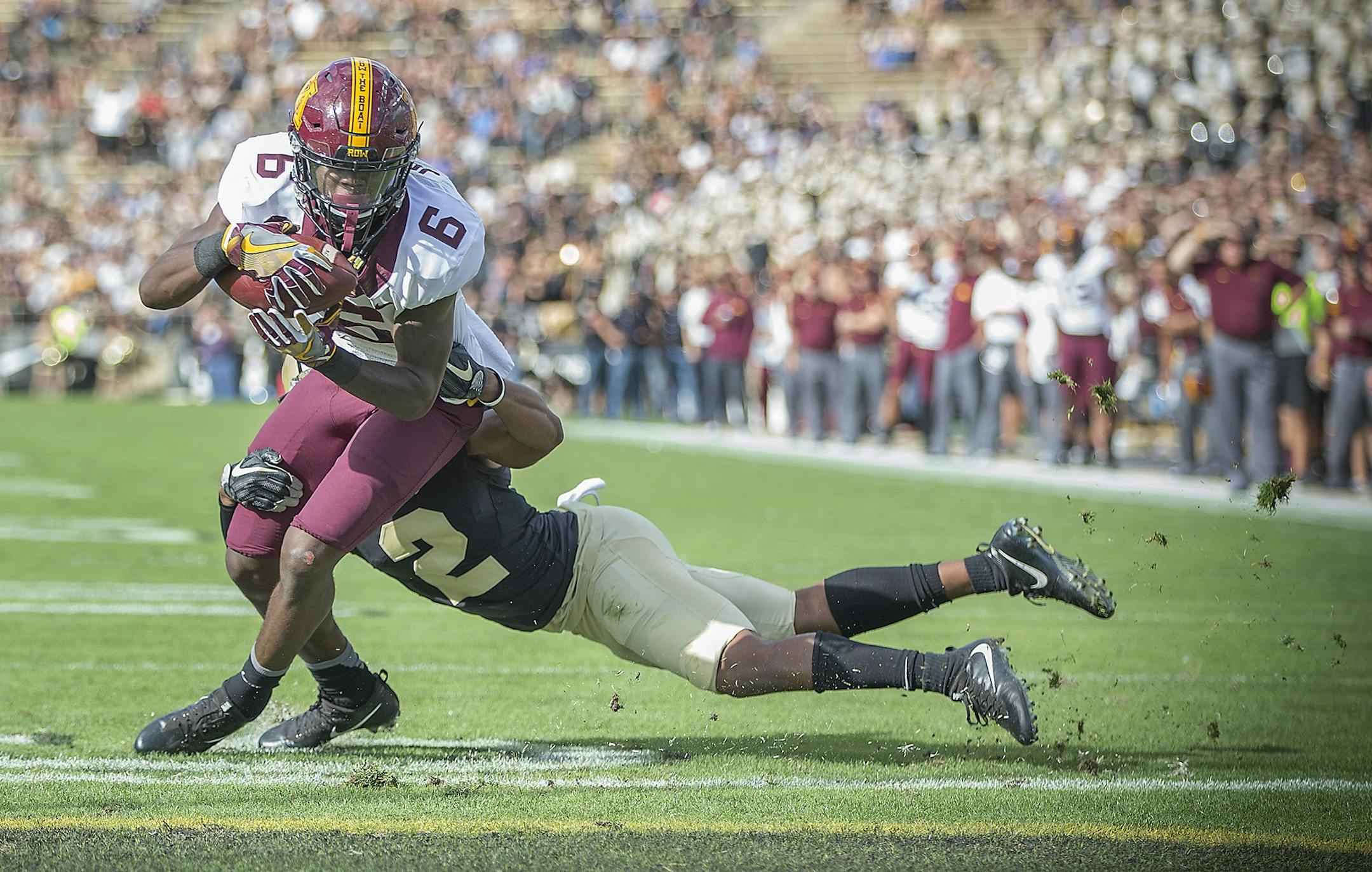 Minnesota's wide receiver Tyler Johnson ran the ball into the end zone for a touchdown despite defensive pressure by Purdue's cornerback Da'Wan Hunte during the first quarter the Gophers took on Purdue at Ross-Ade Stadium, Saturday, October 7, 2017 in West Lafayette, IN.