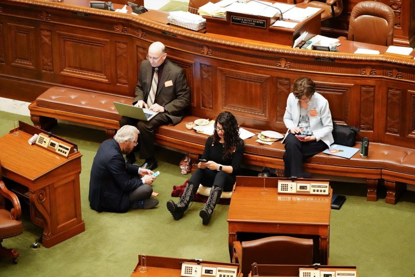 Erin Maye Quade of Apple Valley holds a 24-hour sit-in on the House floor for stronger gun laws. Other DFL reps are joining her. She is here with Raymond Dehn, Minneapolis, Peter Fischer, Maplewood and JoAnn Ward, Woodbury.