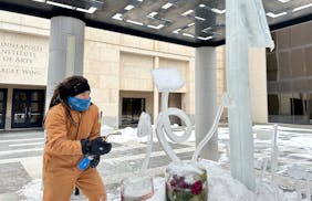 Artist Andrew Bentley created ice flower sculptures outside the Minneapolis Institute of Art on Friday.