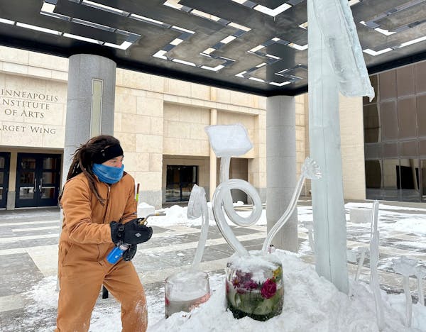 Artist Andrew Bentley created ice flower sculptures outside the Minneapolis Institute of Art on Friday.