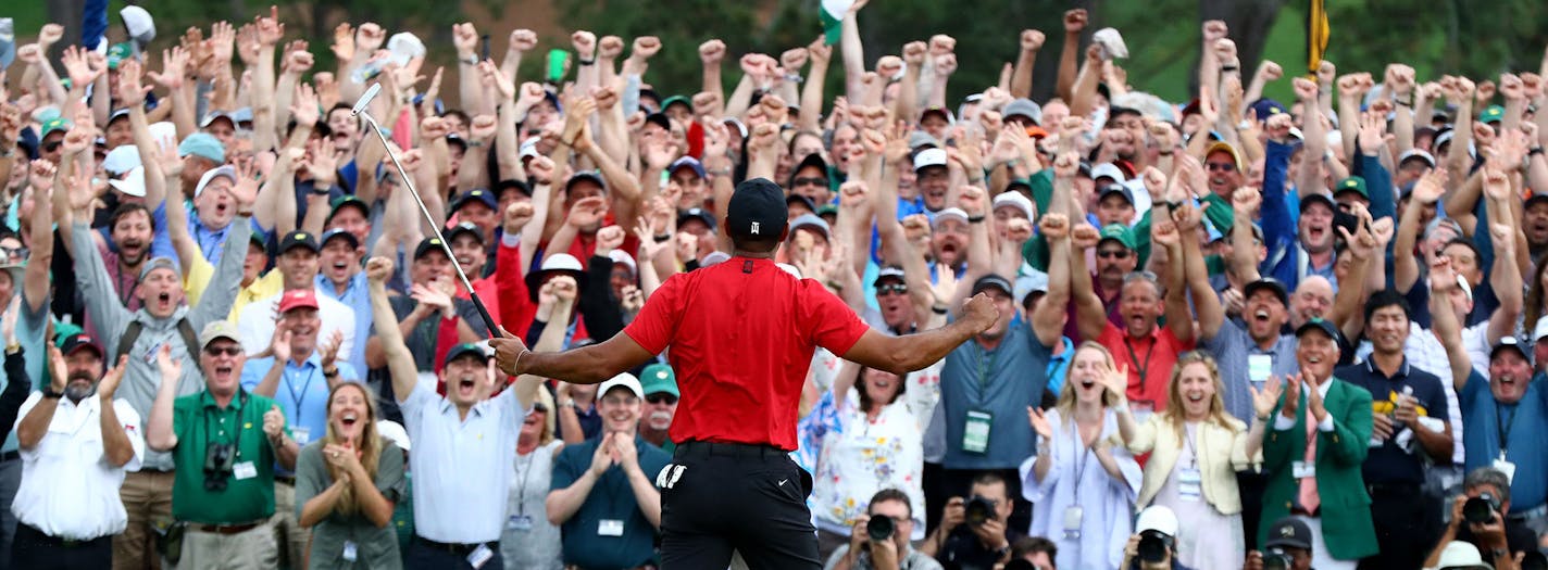 The patrons roar as Tiger Woods sinks his par putt to win the Masters at Augusta National Golf Club on Sunday, April 14, 2019, in Augusta, Ga. (Curtis Compton/Atlanta Journal-Constitution/TNS) ORG XMIT: 1302029