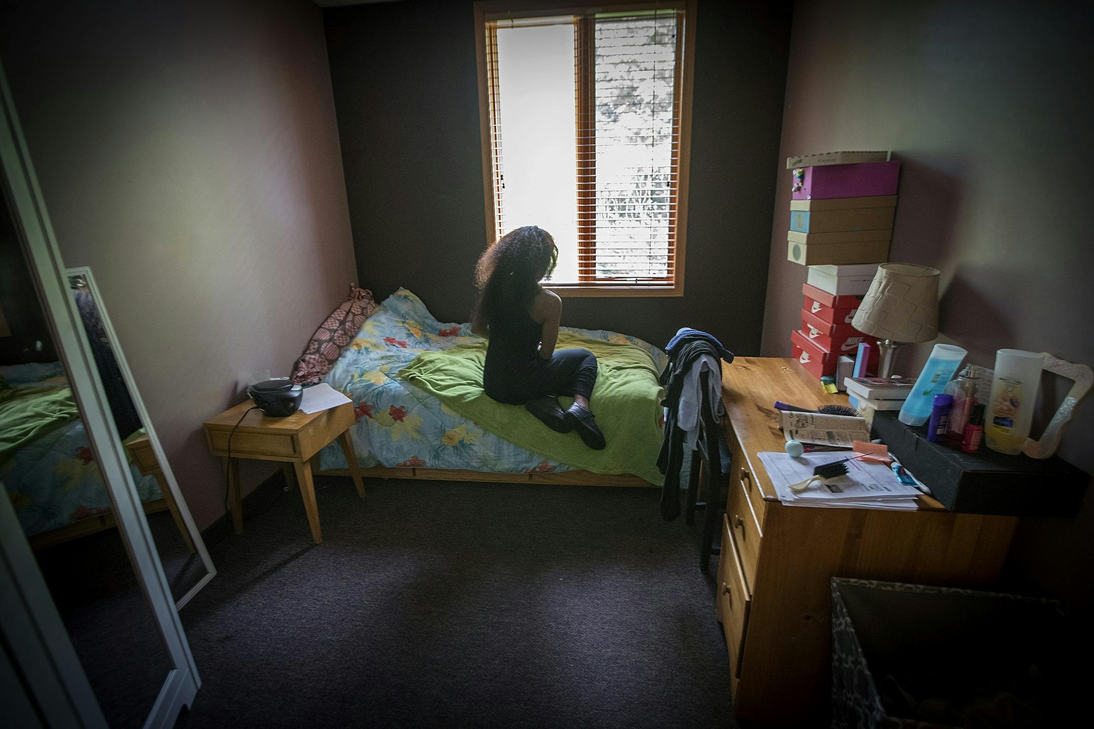 A young sex trafficking victim sat in her room between classes at the Link's Passageways shelter and gousing program in Prior Lake.