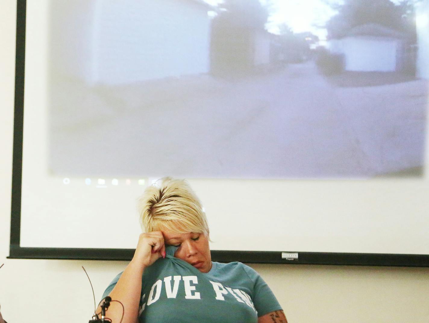 During a press conference about a police body cam video released that shows dogs being shot by a Minneapolis police officer, the dogs owner Jennifer LeMay wipes away a tear while the video played during at the Minneapolis Urban League Wednesday, July 19, 2017, in Minneapolis, MN.] DAVID JOLES &#xef; david.joles@startribune.com about police body cam video being released that shows dogs being shot by police.** Jennifer LeMay,Mike Padden, cq