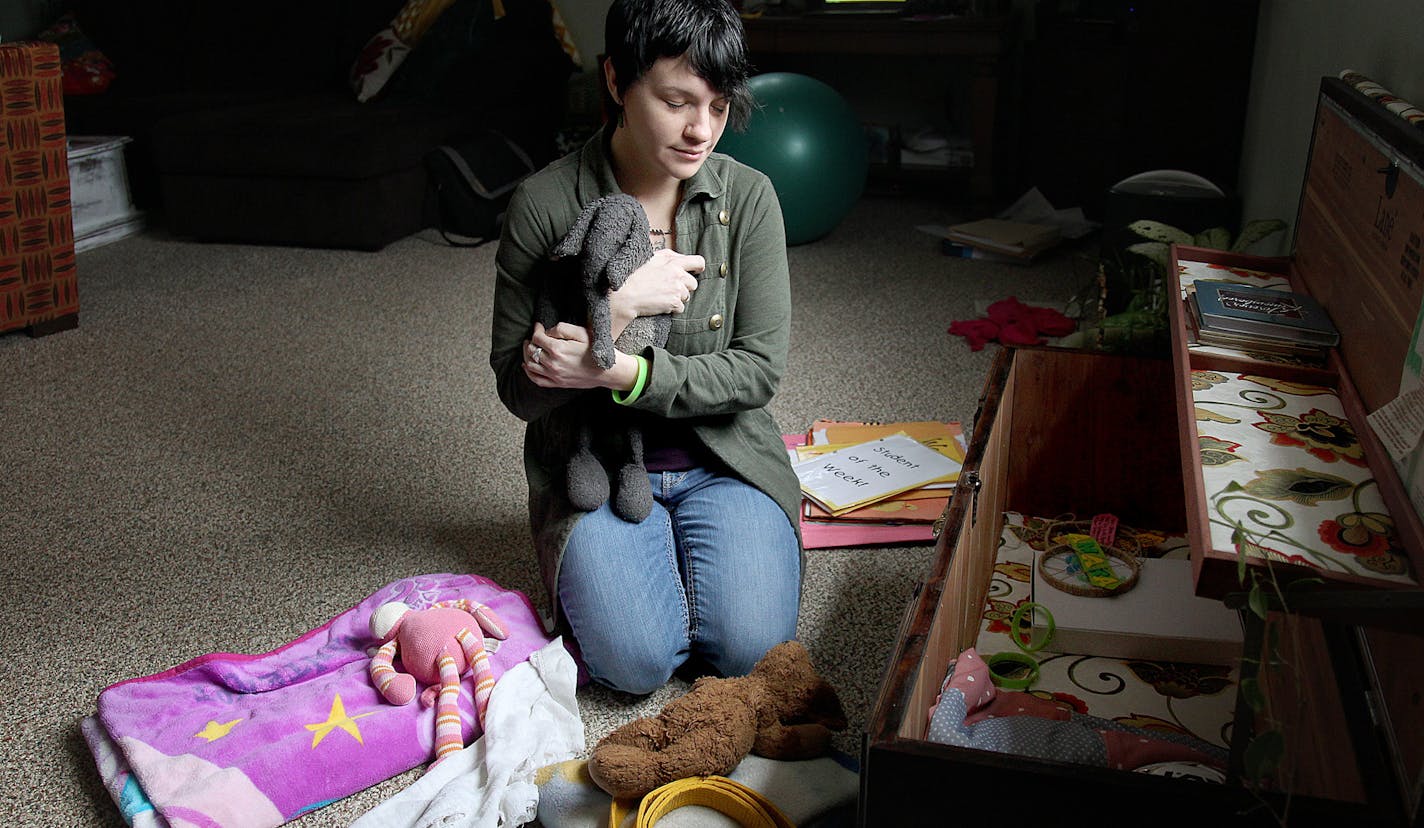 Jessica Schaffhausen sifted through a hope chest filled with her three daughters' toys, blankets, books, and artwork at her home, Friday, April 19, 2013. (ELIZABETH FLORES/STAR TRIBUNE) ELIZABETH FLORES &#x2022; eflores@startribune.com