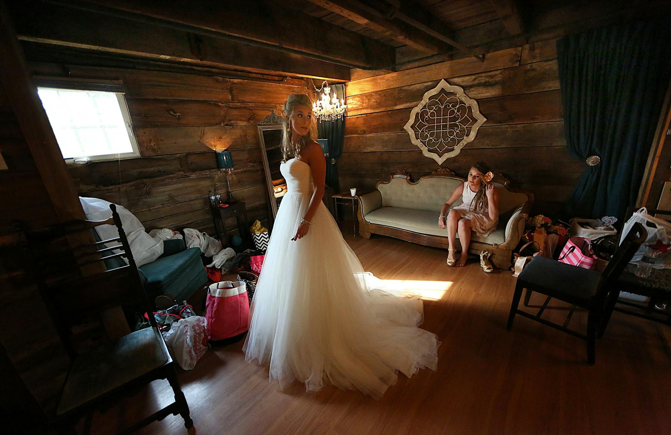 Bride Savannah Koehnen waited in a dressing room at Hope Glen Farm, just moments before she was to join her father, Gary Koehnen, to walk up the aisle. The groom was Jeremy Eckert. With Savannah was her sister, Paige.