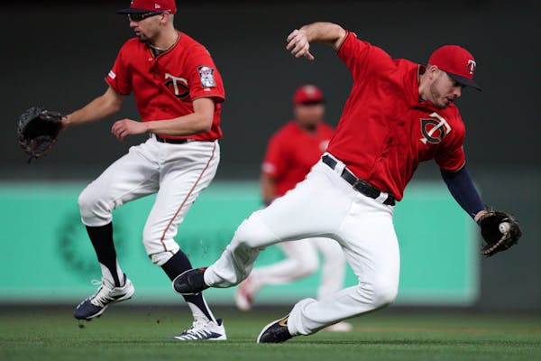 Minnesota Twins first baseman C.J. Cron (24) collided with starting pitcher Devin Smeltzer (31) as he tried to field a single hit by Cleveland Indians