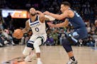 Timberwolves guard D'Angelo Russell handles the ball against Memphis guard Desmond Bane in the second half Thursday