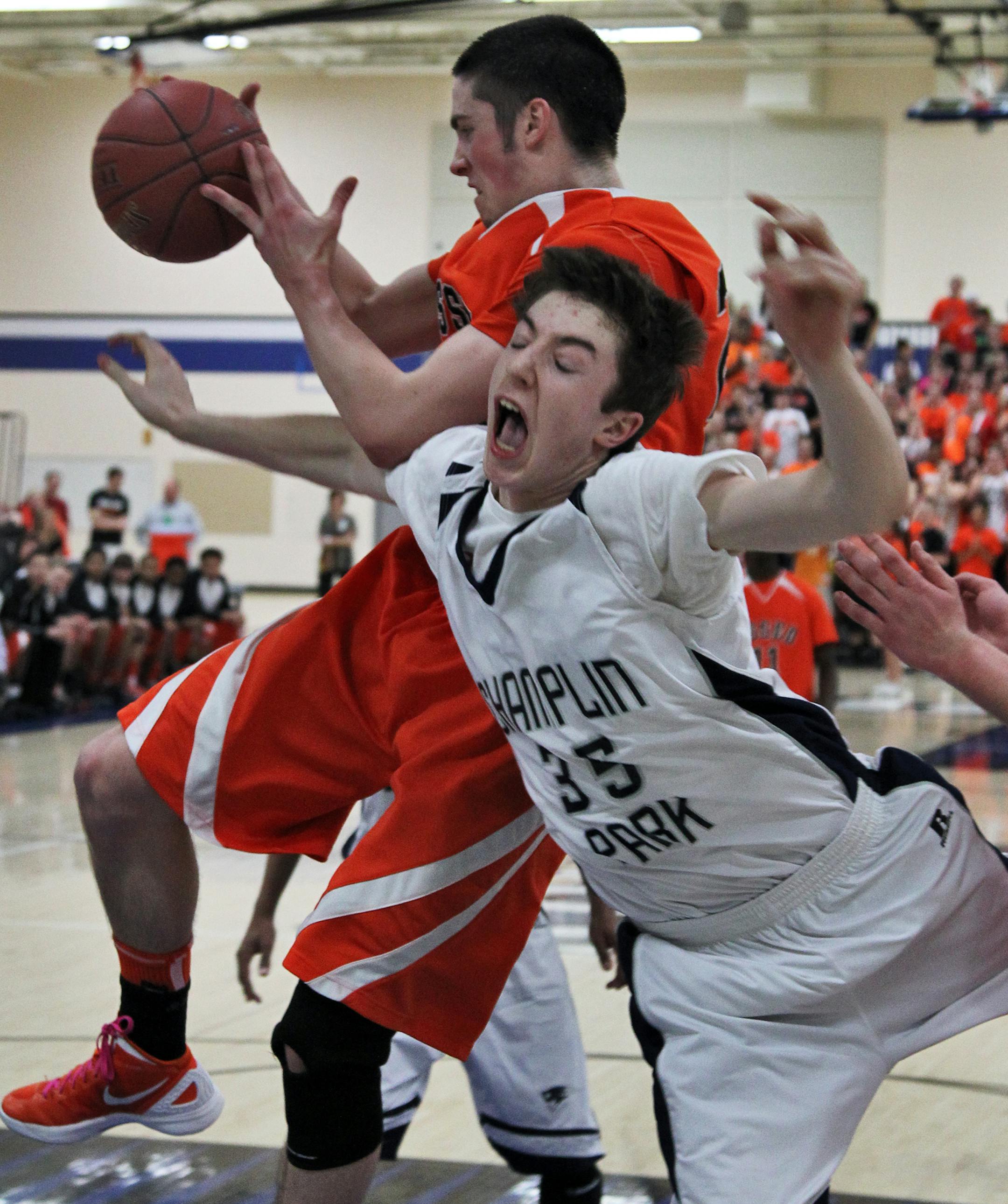 Osseo's Michael Brush grabbed a rebound away from Champlin Park's Brennan Witt.