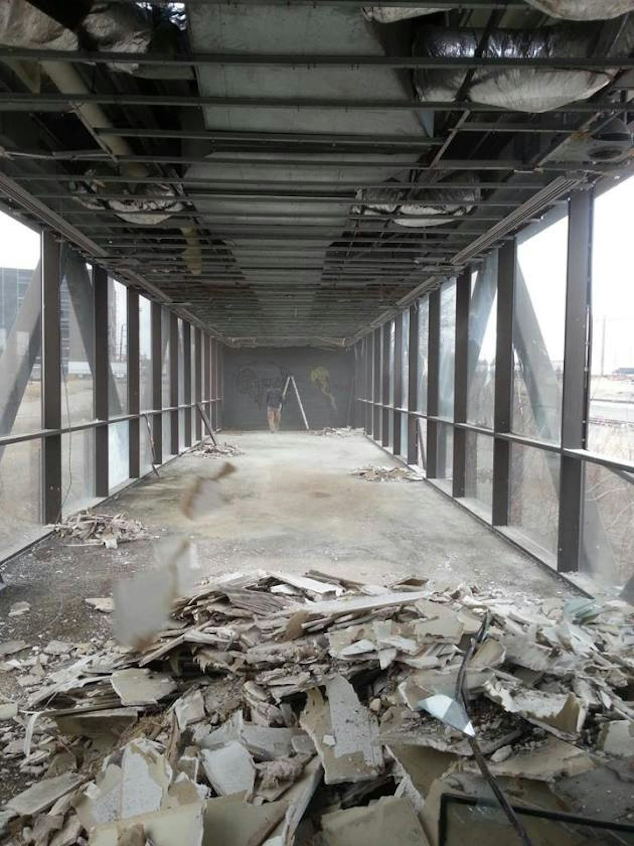 To prepare the skyway for the installation and move, crews are busy removing an old concrete floor and ductwork.