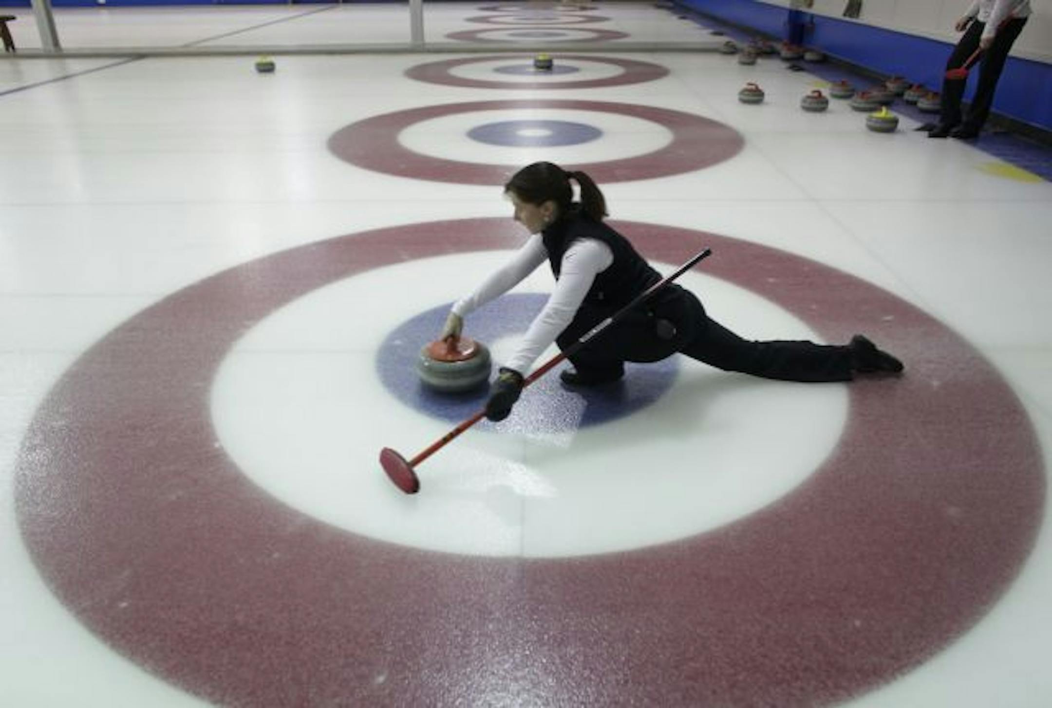 Olympic curler Allison Pottinger slid the stone down the ice during her hour long practice at the St. Paul Curling Club.