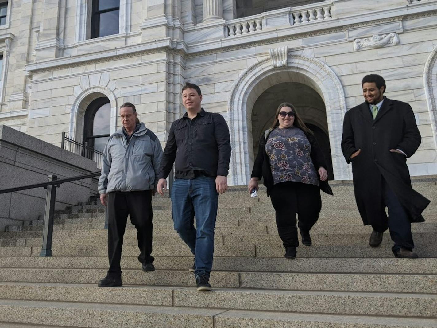 Disability advocates descended the steps of the State Capitol in St. Paul on Wednesday afternoon after testifying in support of legislation that would phase out the practice of paying workers with disabilities less than the minimum wage. Here, right to left, are Noah McCourt, Jillian Nelson, Chris Juhn, and Bradford Teslow.