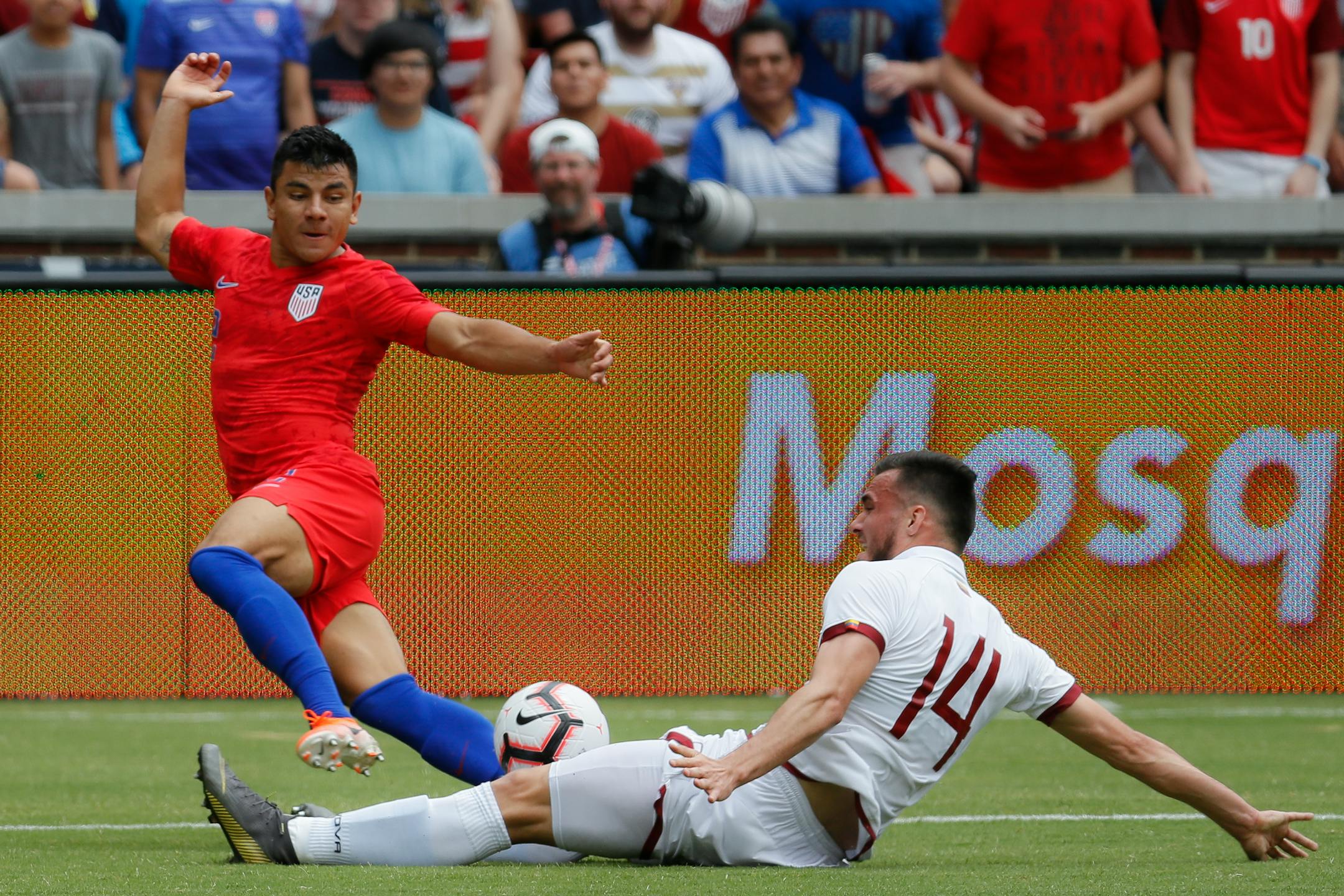 Venezuela defender Luis Mago (14) defended against U.S. defender Nick Lima, left, during the first half of an international friendly soccer match Sunday in Cincinnati. Venezuela won 3-0.