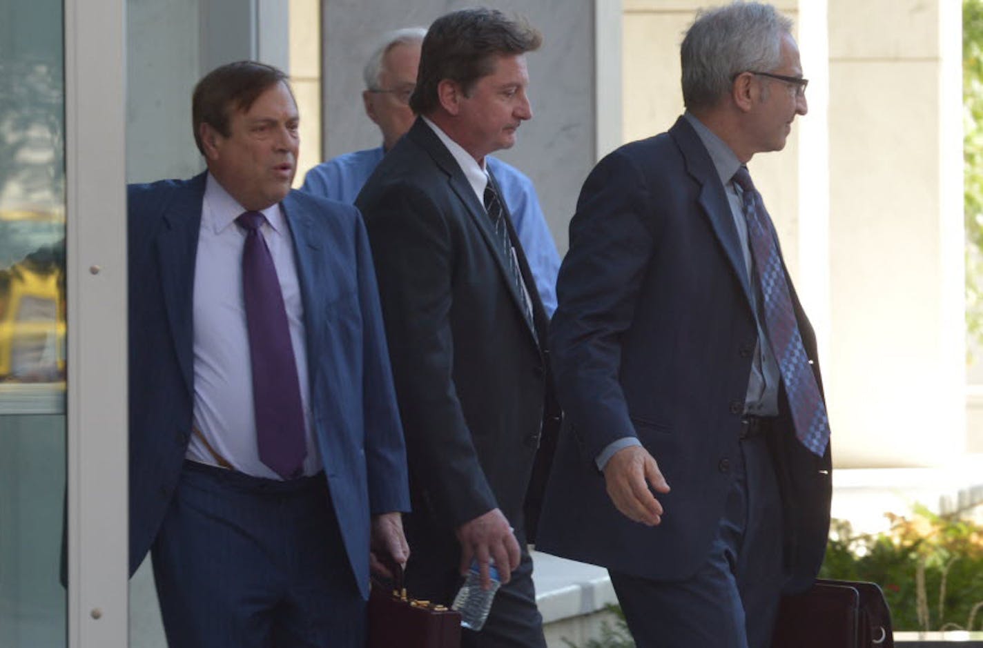 James Fry (carrying water bottle) left the federal courthouse in St. Paul on Wednesday after being sentenced for his role in the Tom Petters fraud case.
.