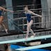 CORRECTS TO SAY IT WAS AN OFFICIAL PERFORMANCE, NOT A WARM-UP - Sarah Bacon and Kassidy Cook of the United States dive in the women's synchronized 3-m