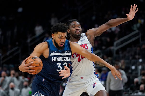 Timberwolves center Karl-Anthony Towns (32) drives on Pistons center Isaiah Stewart (28) in the first half Thursday. 