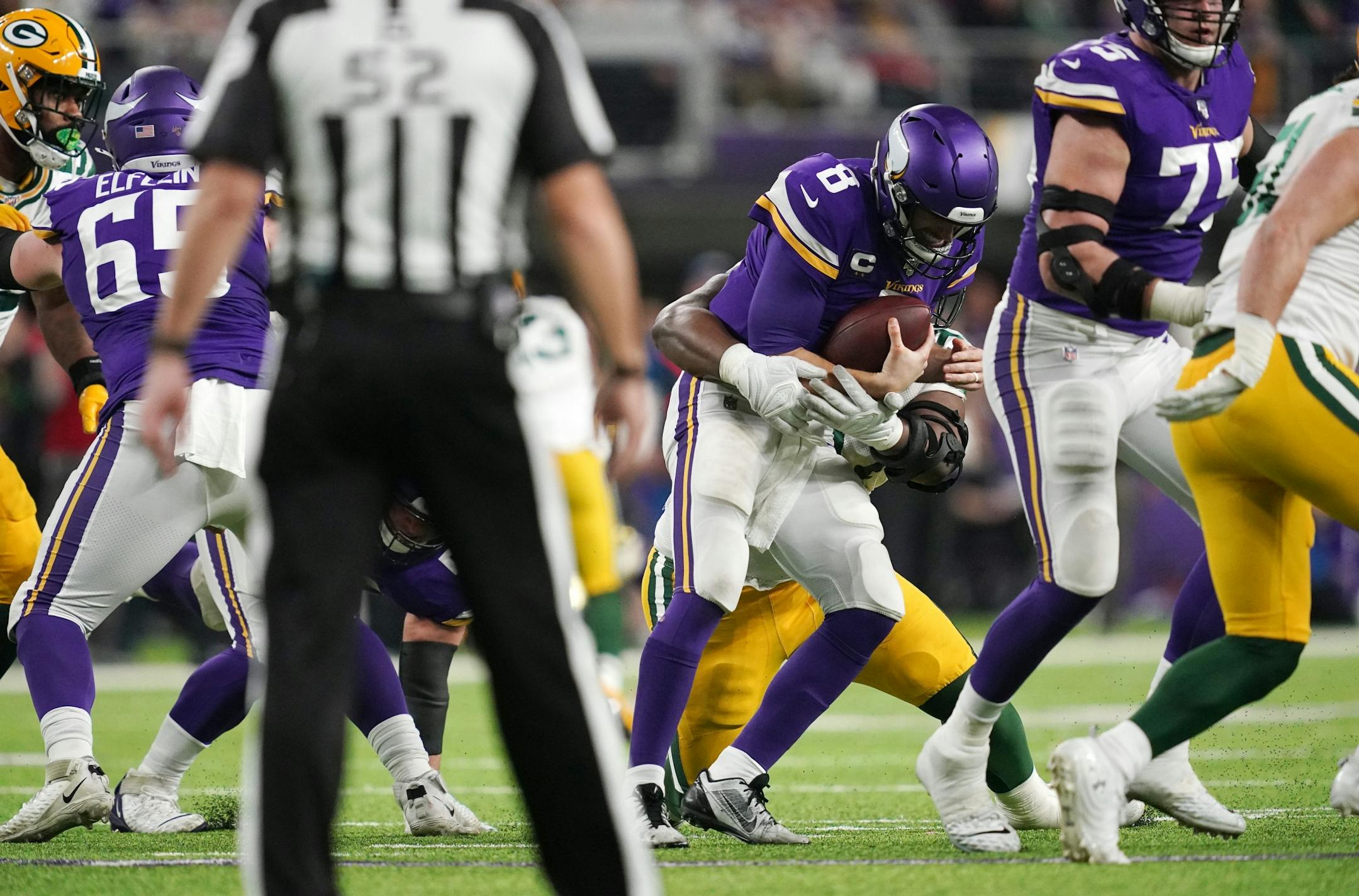 Minnesota Vikings quarterback Kirk Cousins (8) was sacked by Green Bay Packers nose tackle Kenny Clark (97) in the fourth quarter. Cousins is now 0-9 in his career on Monday Night Football.