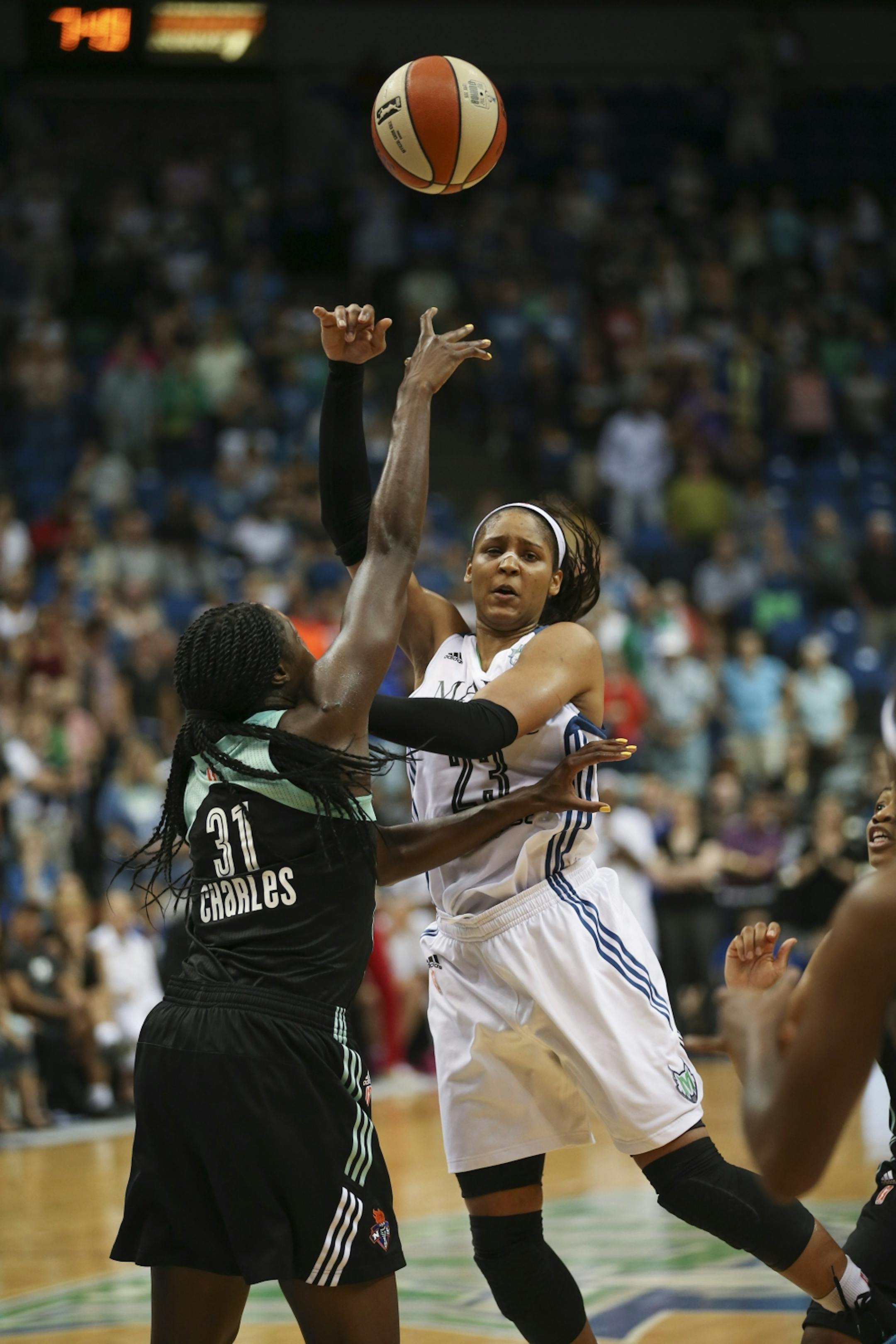 While defended by New York center Tina Charles (31) with under a minute left in the fourth quarter, Minnesota Lynx forward Maya Moore (23) had her pass stolen by Liberty guard Tanisha Wright Sunday night.