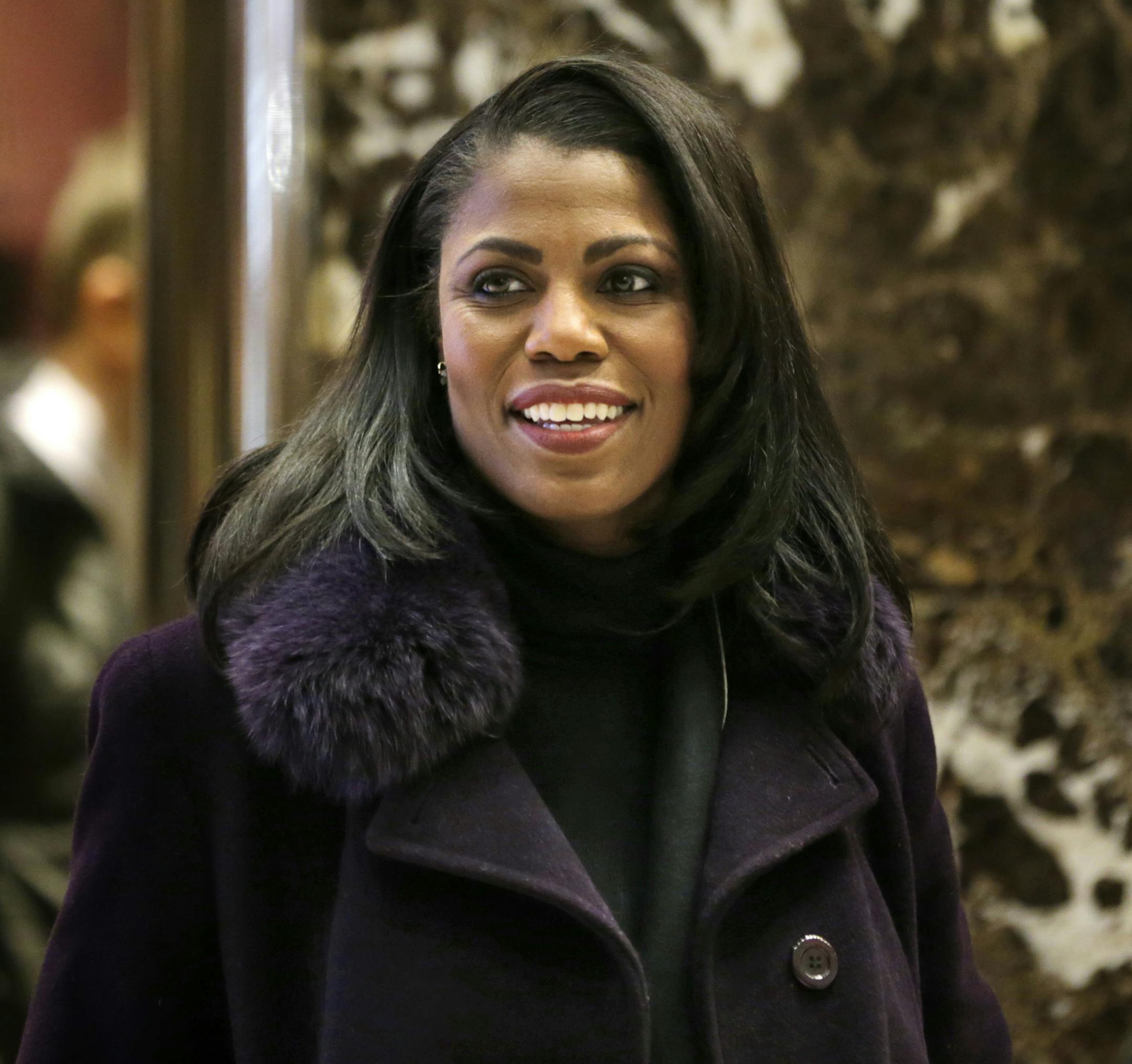 FILE - In this Dec. 13, 2016 file photo, Omarosa Manigault smiles at reporters as she walks through the lobby of Trump Tower in New York. Manigault Newman is following up her year in the White House with a stint on ìCelebrity Big Brother.î CBS unveiled the cast of the reality showís upcoming season Sunday with a commercial that aired during the Grammy Awards.
Besides Manigault Newman, other contestants include basketball star Metta World Peace and actresses Marissa Jaret Winokur a