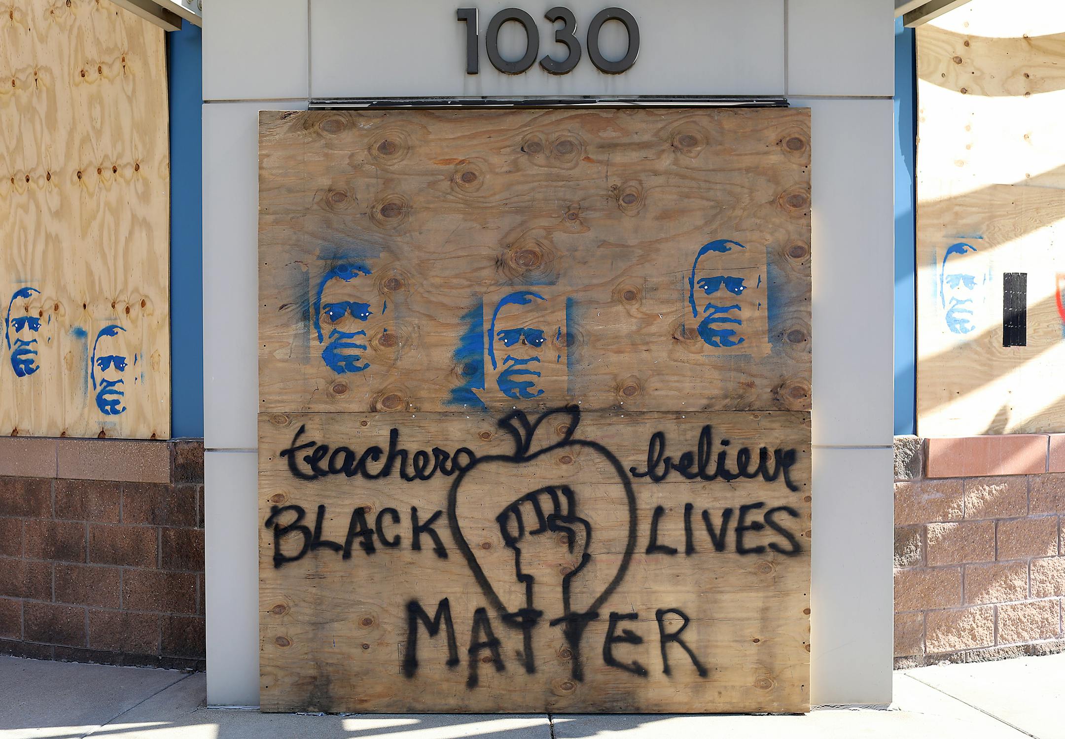 Teacher solidarity with the Black Lives Matter movement is graffitied over boarded-up windows at the Hubbs Center for Lifelong Learning at 1030 University Ave. W. in St. Paul.