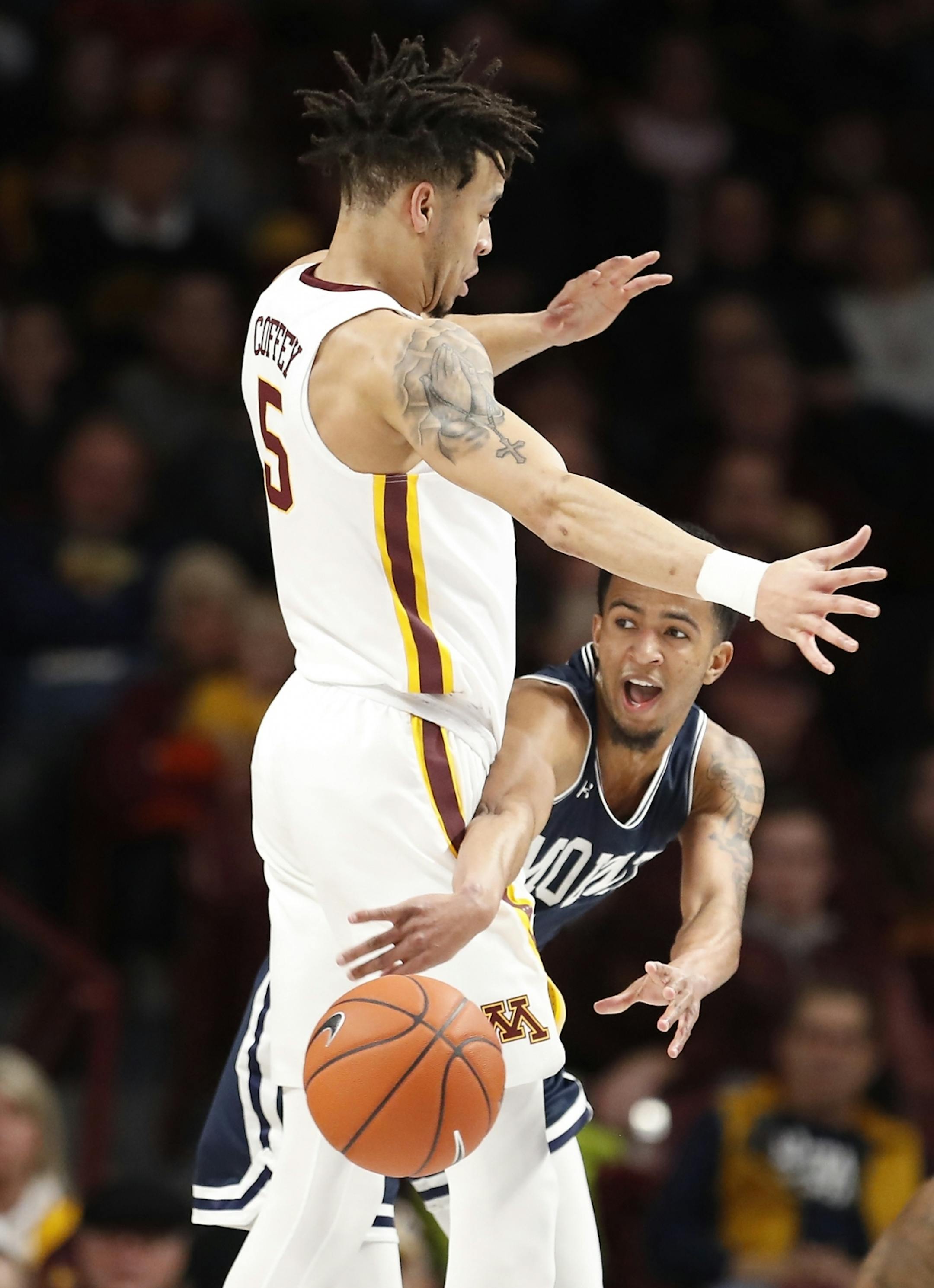 Mount St. Mary's guard Jalen Gibbs (1) makes a low pass around Minnesota guard Amir Coffey (5) during the first half.