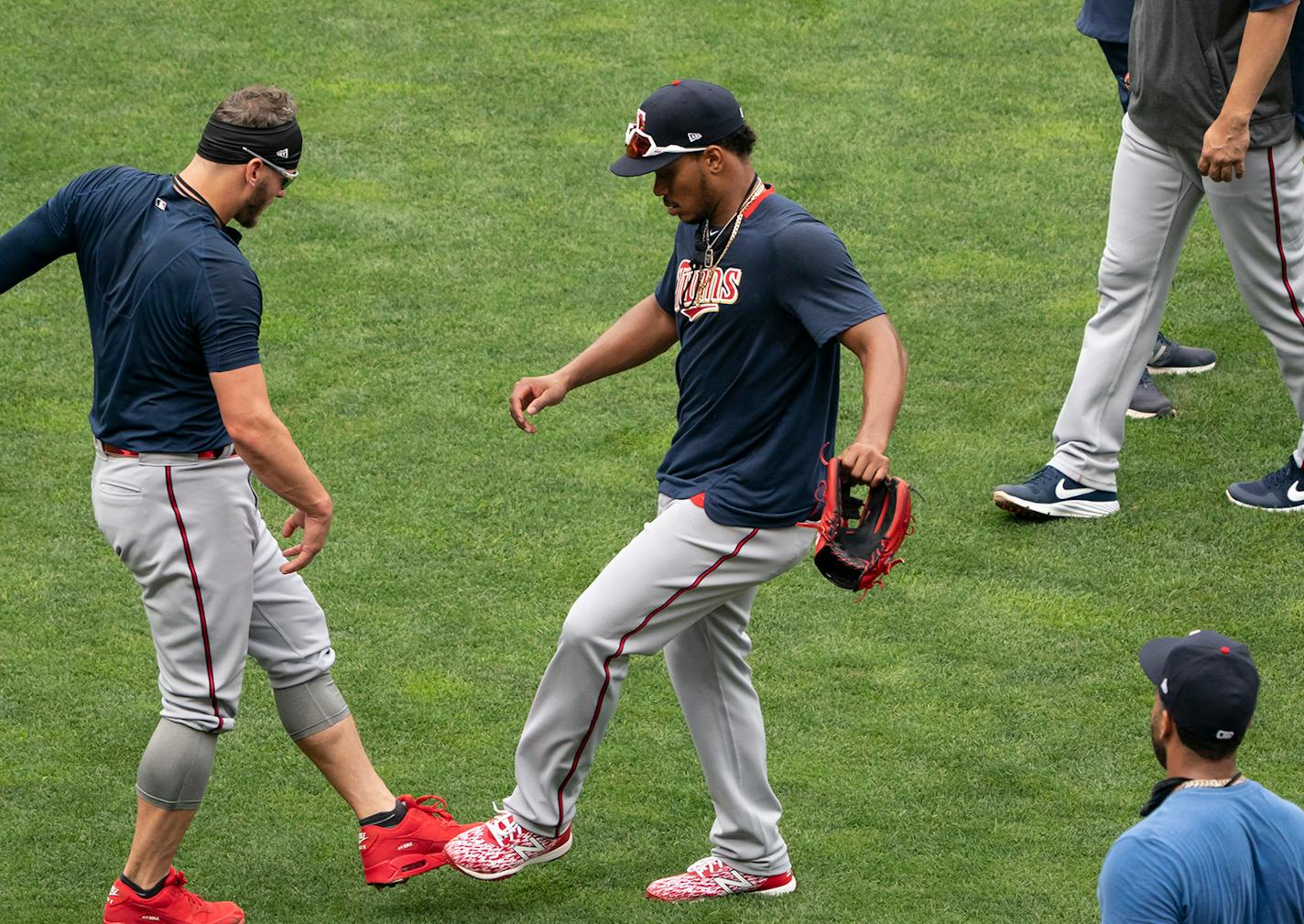 Twins third baseman Josh Donaldson (24) and shortstop Jorge Polanco (11) gave each other foot bumps instead of high fives at practice.