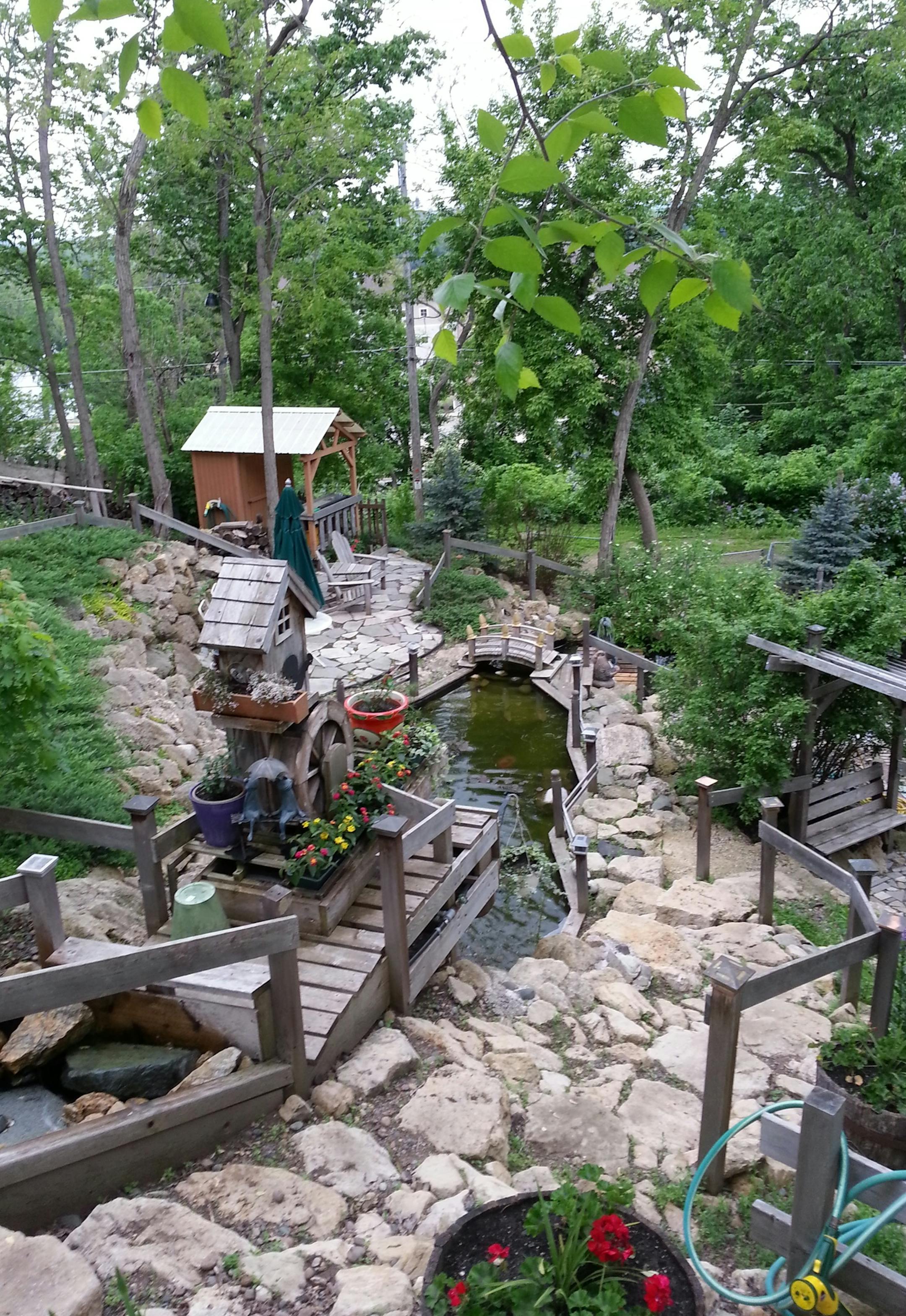 Photo courtesy of Jodi MacLennan. John and Jodi MacLennan, of Prescott, designed and landscaped a steep hillside area in their backyard with limestone stairs and walkways and a series of waterways and waterfalls.