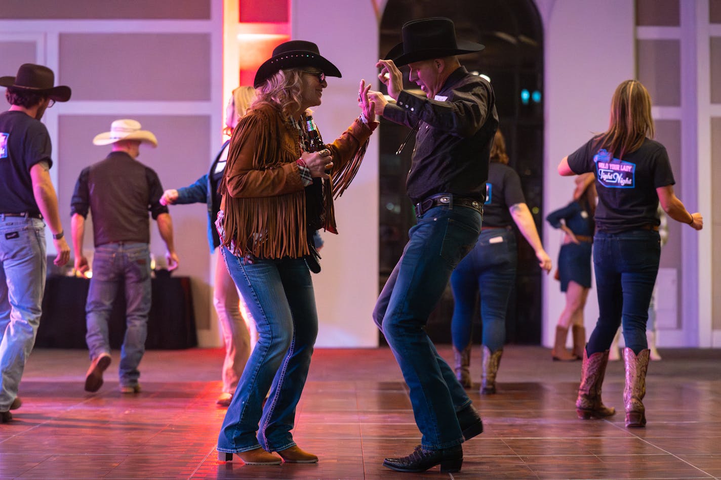 Terri "Skip Lady" Ptacek and Patrick Smith danced to Coyote Wild's set at the Ryan Companies' western-themed holiday party in Brooklyn Center.