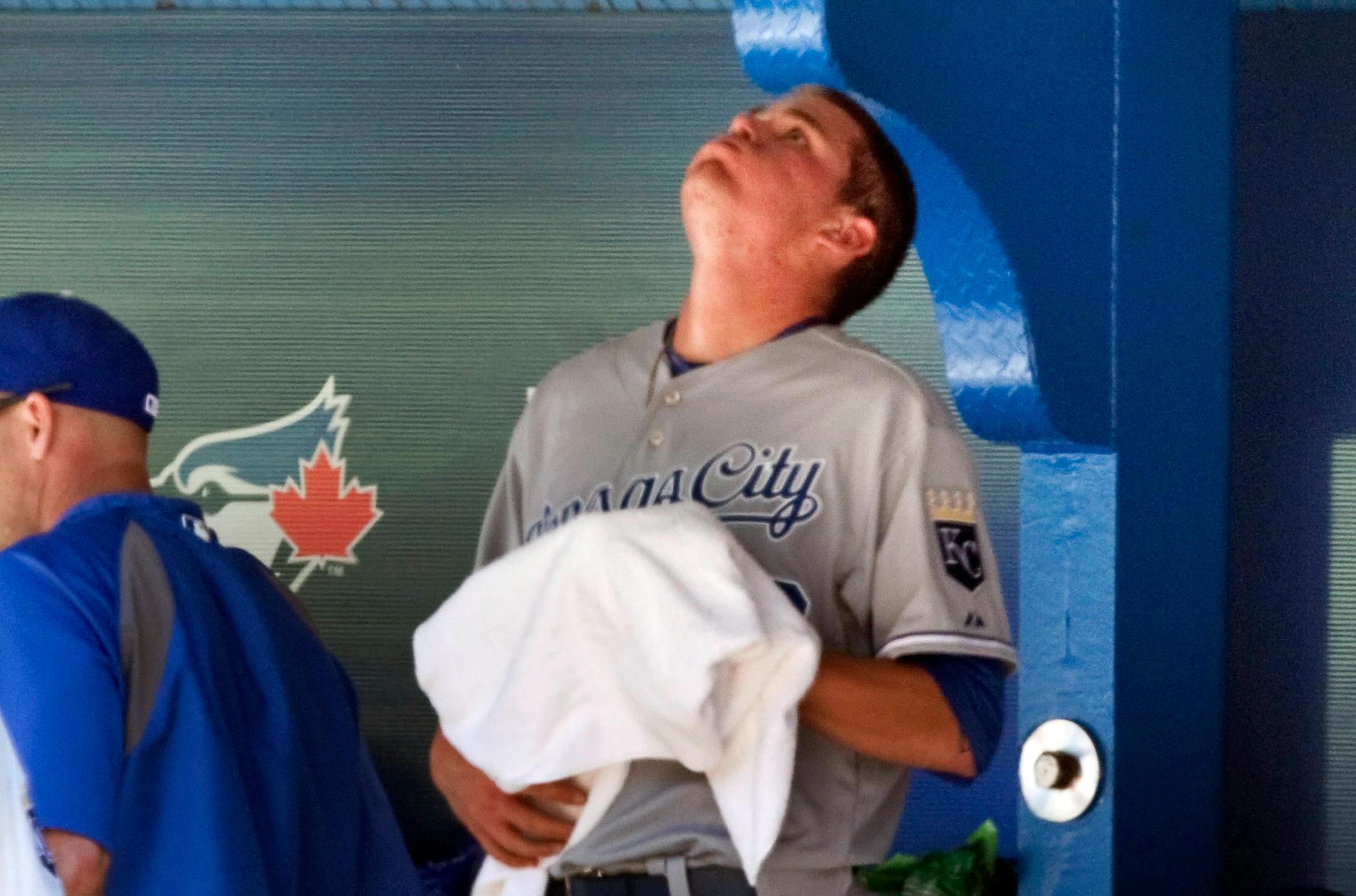 Kansas City Royals starting pitcher Aaron Brooks reacts in the dugout after being taken out after he gave up seven runs to the Toronto Blue Jays in first inning of a baseball game in Toronto, Saturday, May 31, 2014. (AP Photo/The Canadian Press, Fred Thornhill)