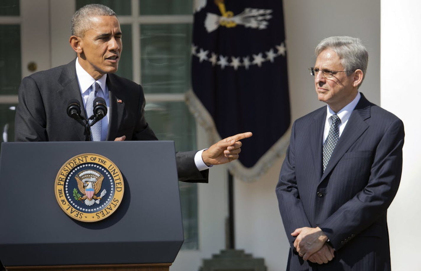 Federal appeals court judge Merrick Garland, right, stands with President Barack Obama as he is introduced Wednesday as Obama's nominee for the Supreme Court during an announcement in the Rose Garden of the White House, in Washington.