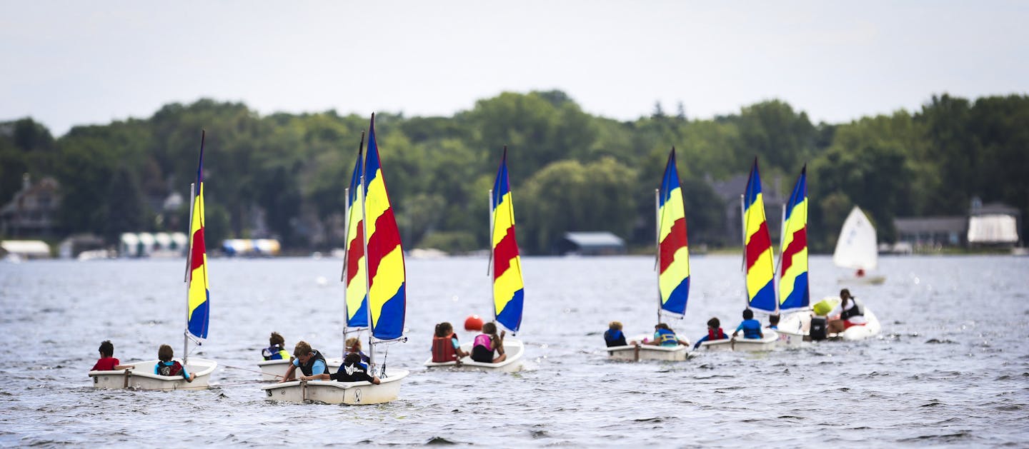 A group of children were pulled in a line as they sailed on Lake Minnetonka as part of a Wayzata Community Sailing Center summer camp class on Thursday, July 24, 2014, in Wayzata, Minn. ] RENEE JONES SCHNEIDER &#x2022; reneejones@startribune.com