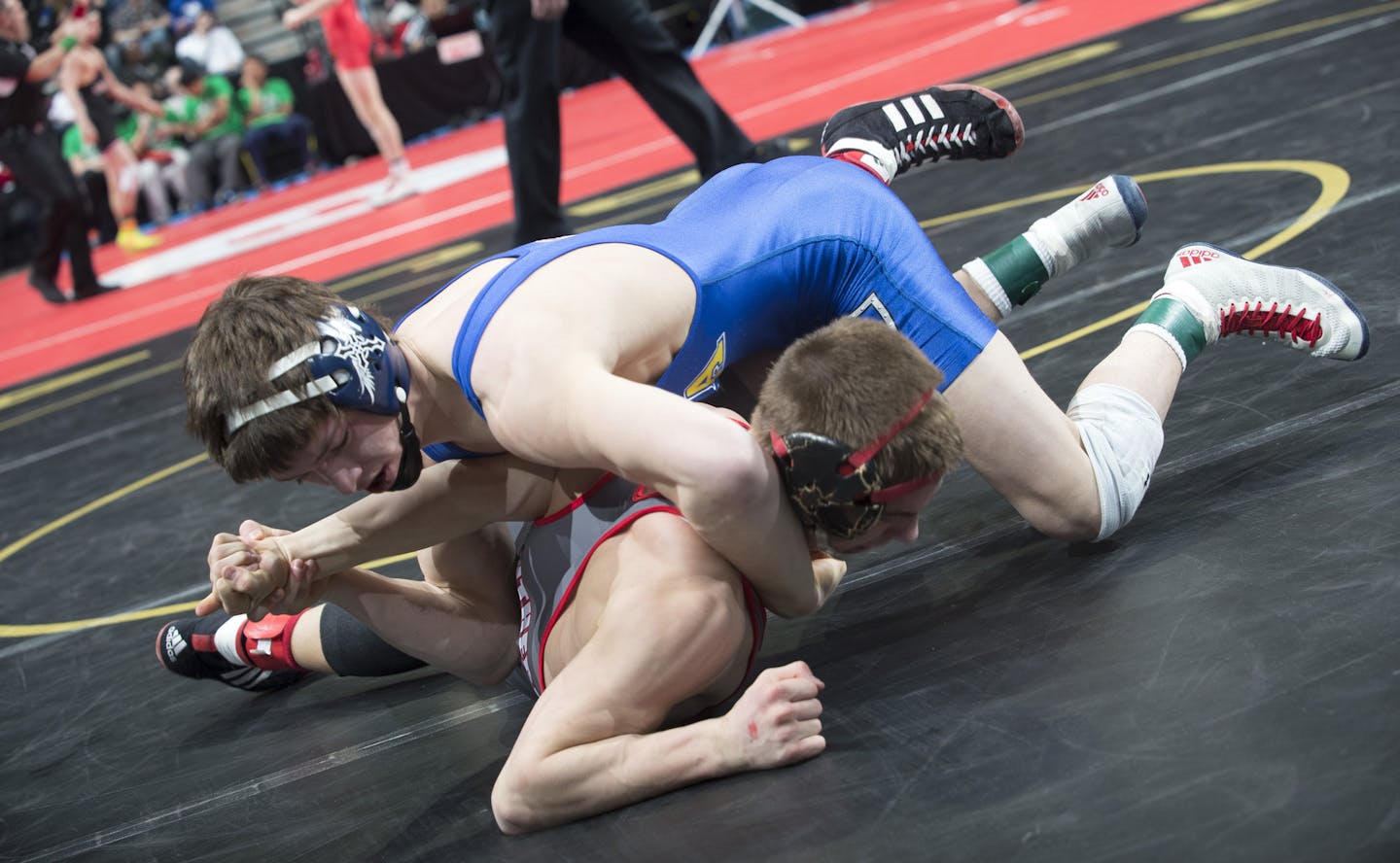 Mitchell McKee, back, of St. Michael-Albertville, tries to flip Wade Sullivan, of Lakeville North, to his back for a pin during the Class 3A prelims on Friday night in the 126 lb. weight class. ] (Aaron Lavinsky | StarTribune) Wrestlers compete in the Class 3A state wrestling individual prelims of the State Wrestling Tournament on Friday, Feb. 27, 2015 at Xcel Energy Center in St. Paul.