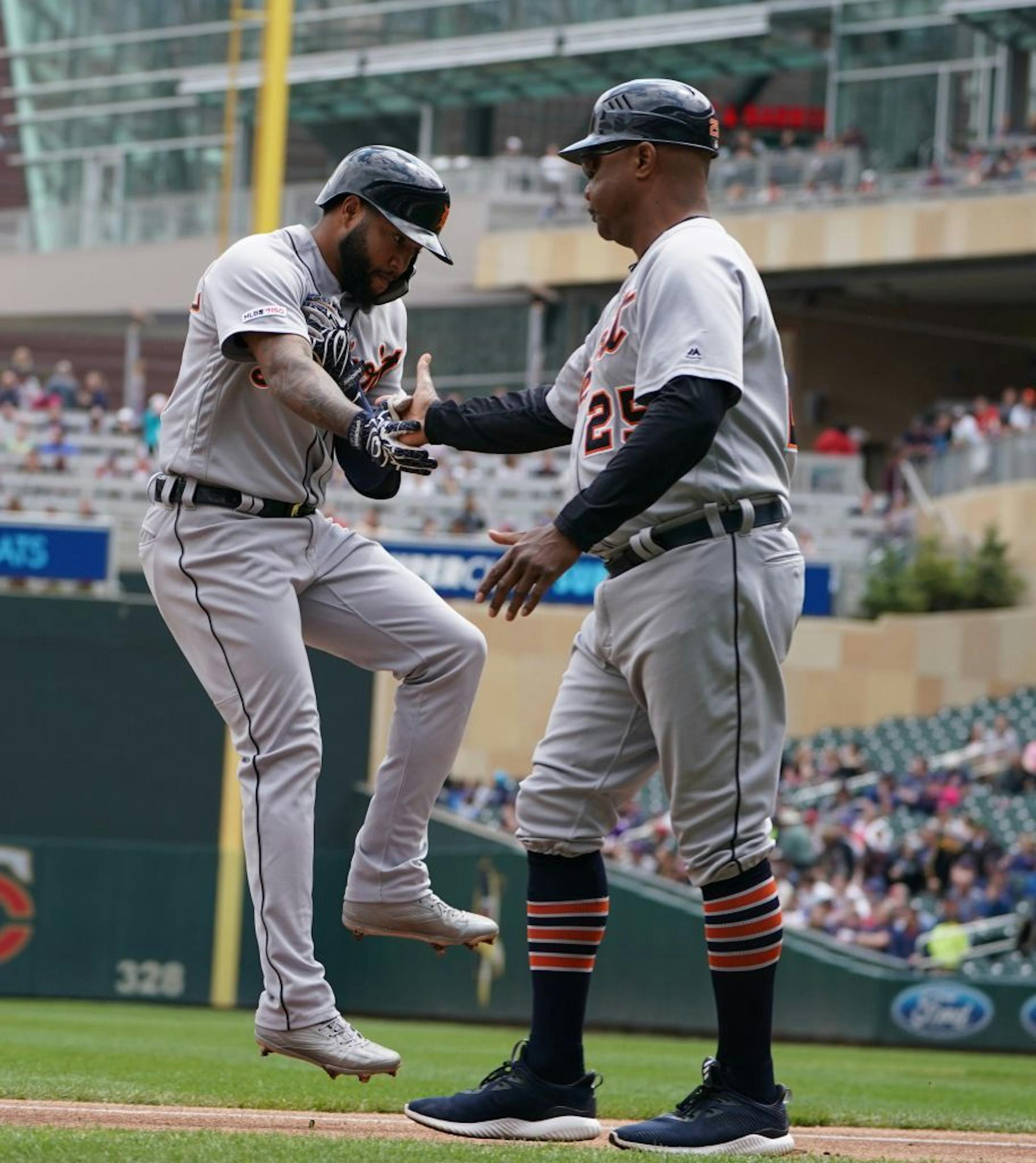 Detroit Tigers third baseman Ronny Rodriguez (60) was congratulated by third base coach Dave Clark (25) after hit a single homerun in the second inning.