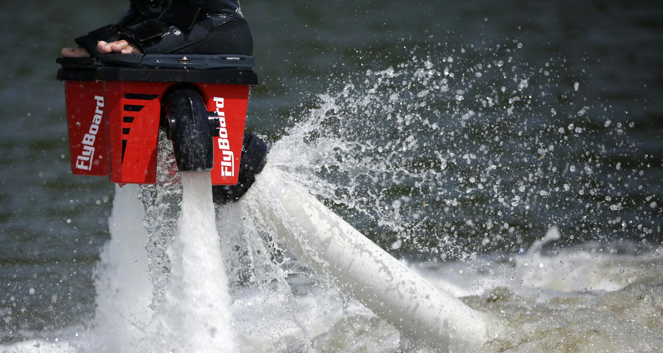 Tom Garneau, of Deephaven, tries flyboarding during a lesson with Rodney Jansen on Friday afternoon at Lake Waconia. He and his friends saw video of the sport online last winter and decided to try it out. ] Rodney Jansen gave flyboarding lessons on Lake Waconia on Friday afternoon. Jansen started flyboarding three years ago, and started his rental company two years ago. His last weeks of summer will be busy as he is booked through the end of the season. MONICA HERNDON Waconia, MN 08/15/14