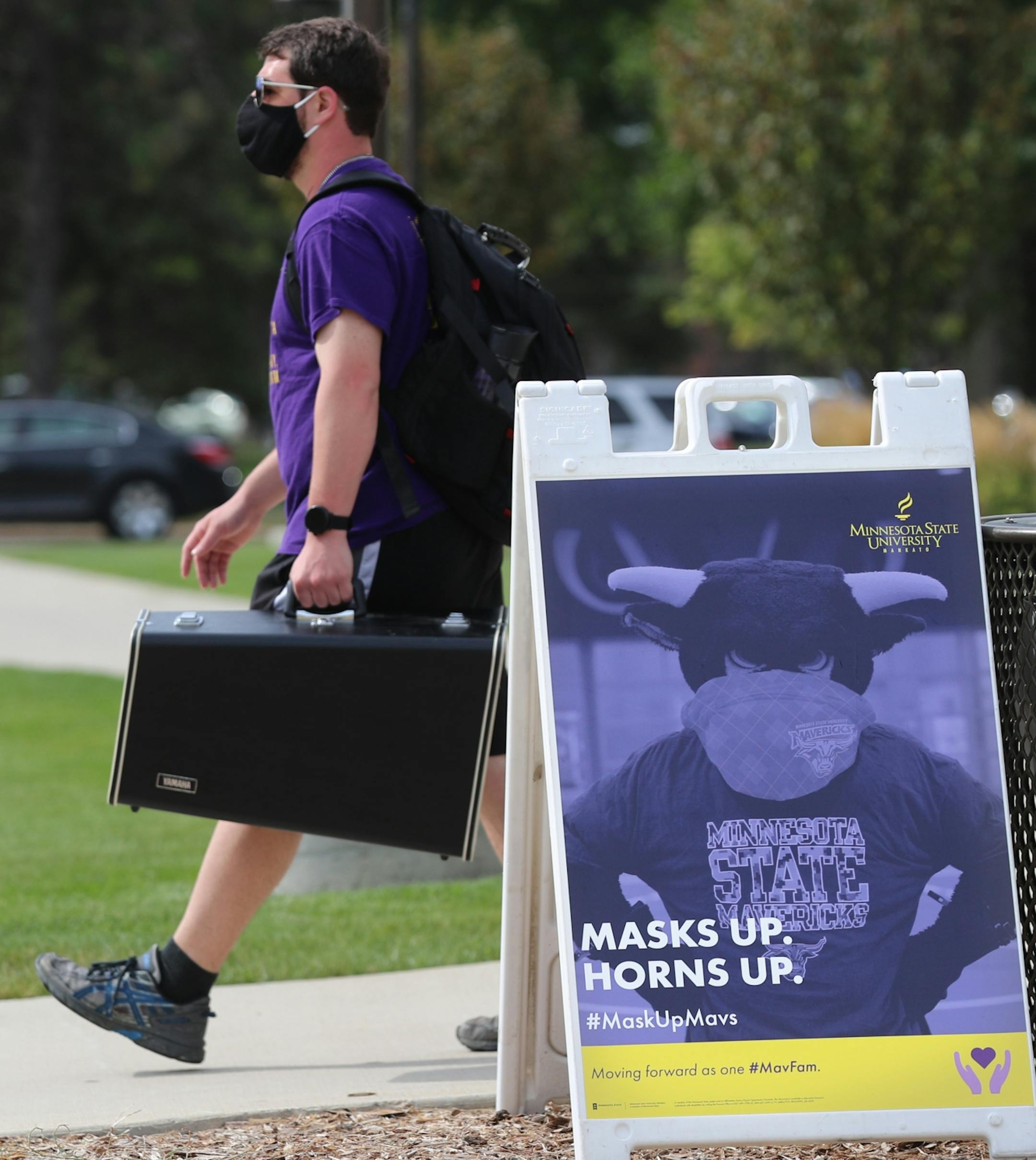 Students began moving into dormitories at Minnesota State University-Mankato Thursday where signs on campus reminded students to wear masks to fight the Coronavirus.